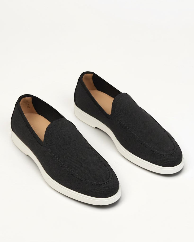 Prestige PS-U5320 Flexy Active black slip-on loafers with a textured fabric upper and a contrasting white rubber sole.
