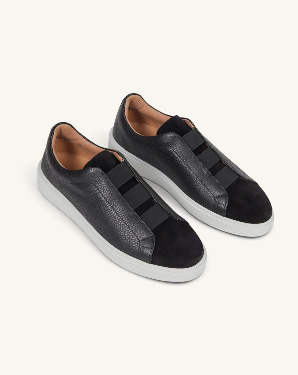 Prestige black sneakers featuring a mix of grained leather and velour with triple stitch details and white soles.