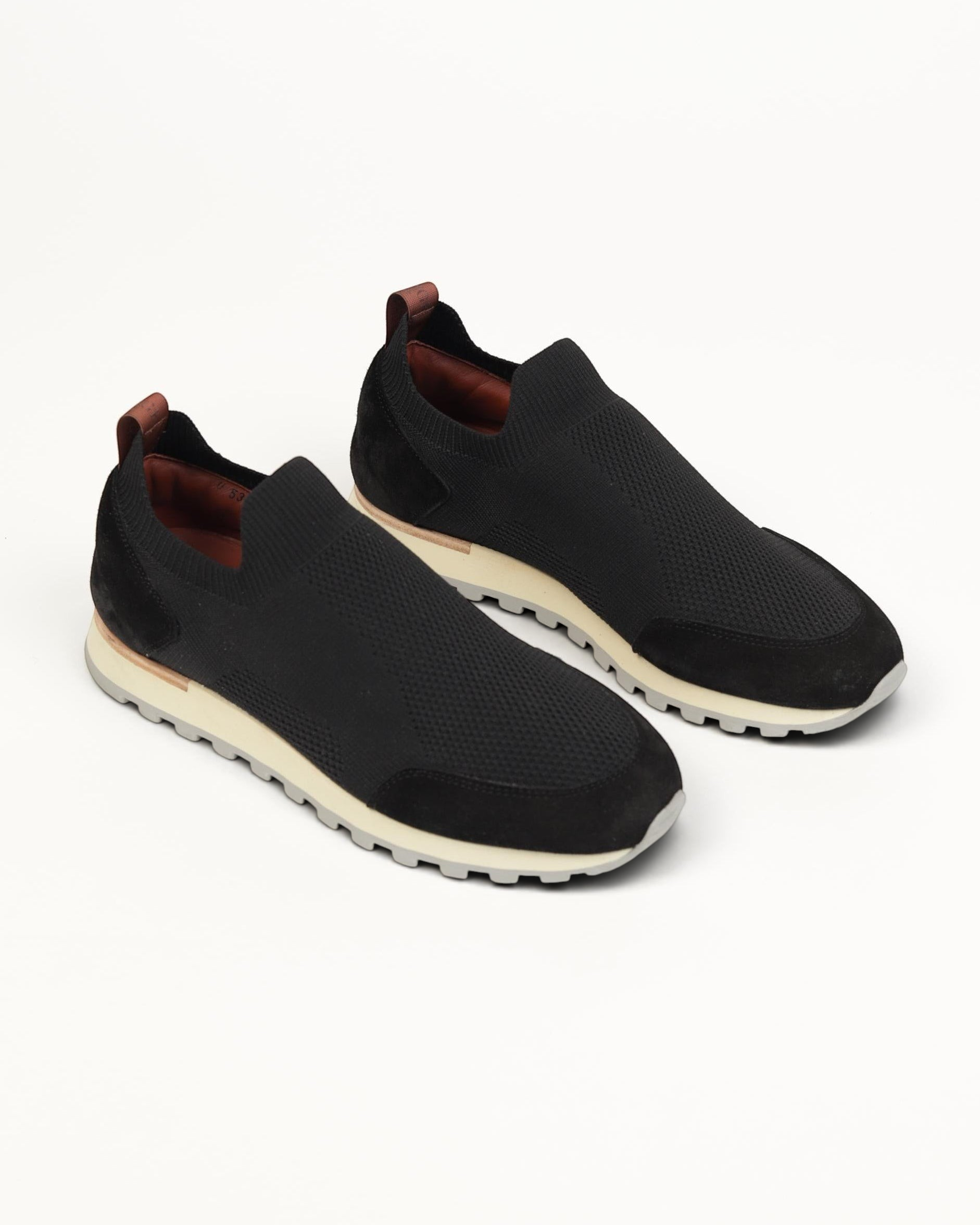 Prestige Flexy Lux active runners in black featuring a slip-on knit upper, suede overlays, and a chunky white sole.