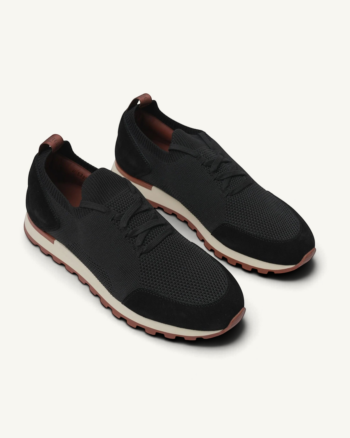 Prestige Flexy Lux black knit sneakers with suede overlays and a contrasting beige and brown rubber sole.