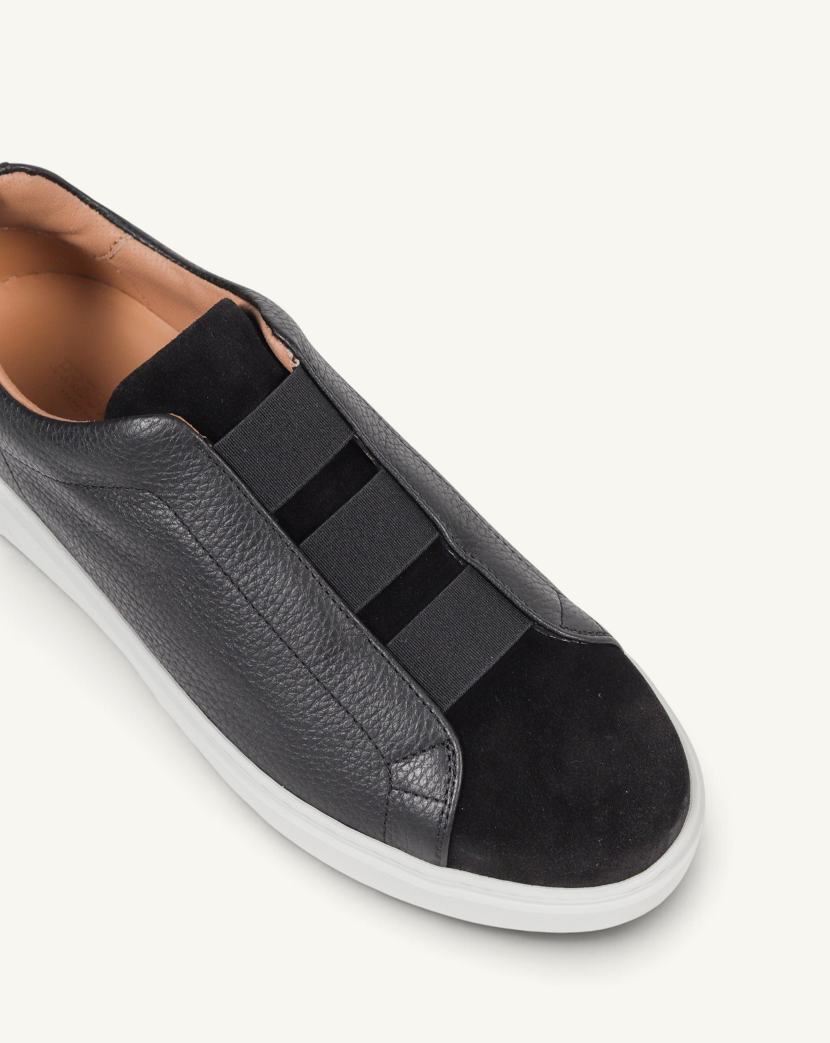 Prestige black slip-on sneakers featuring a mix of grained leather and velour with triple elastic strap detailing.