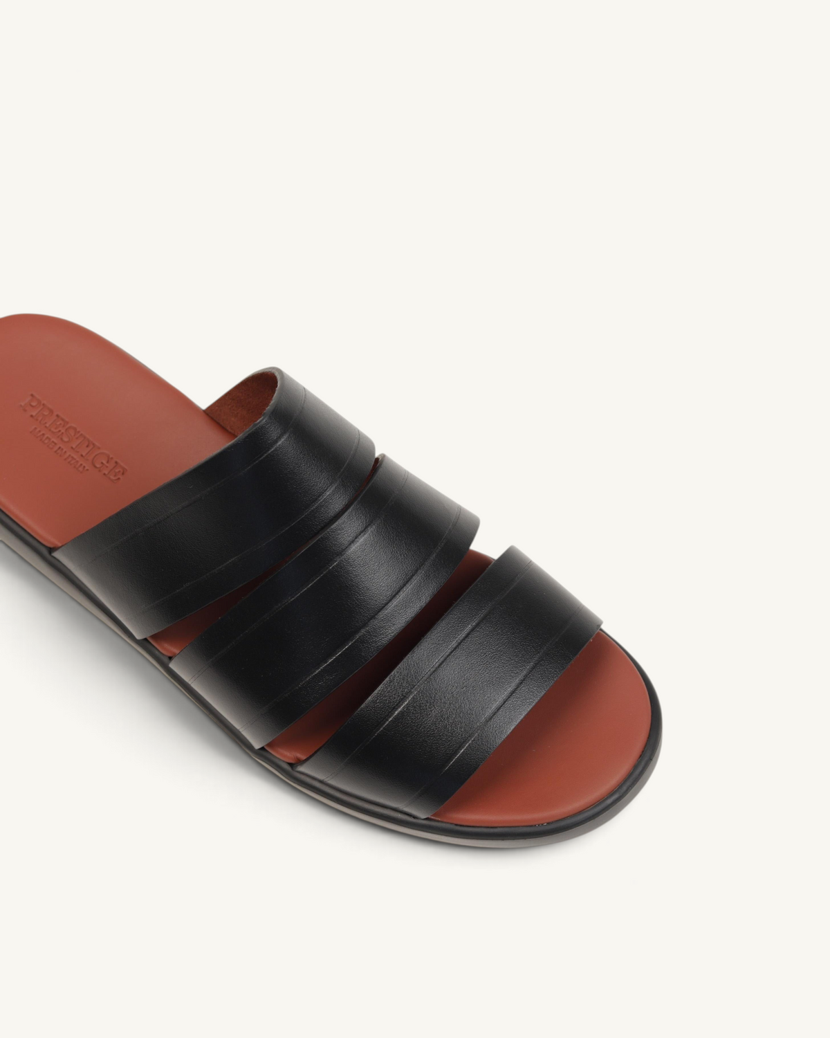 Prestige black soft nappa calf leather slide sandals with a contrasting tan footbed and triple strap design