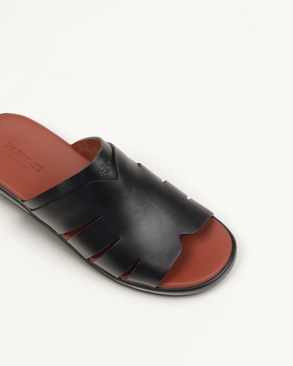 Prestige black soft nappa calf leather slide sandal with cut-out details and a tan leather footbed