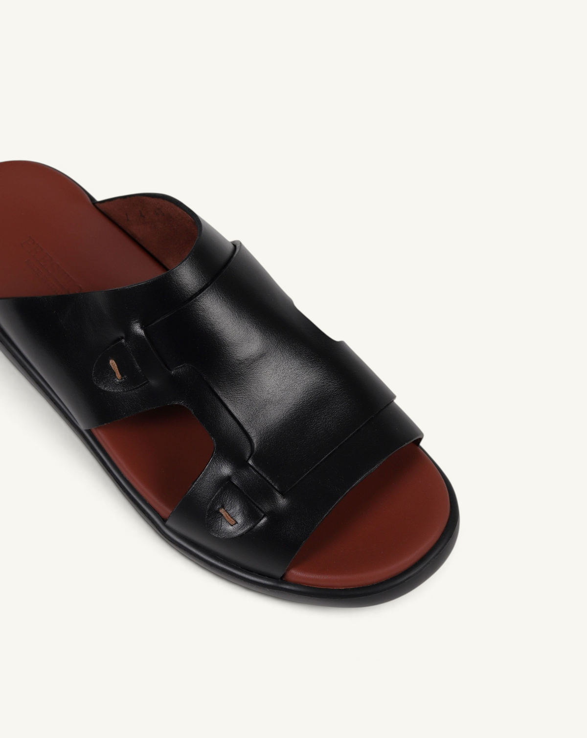 Prestige black soft nappa calf leather slide sandal with a contrasting brown footbed and stitched detailing.