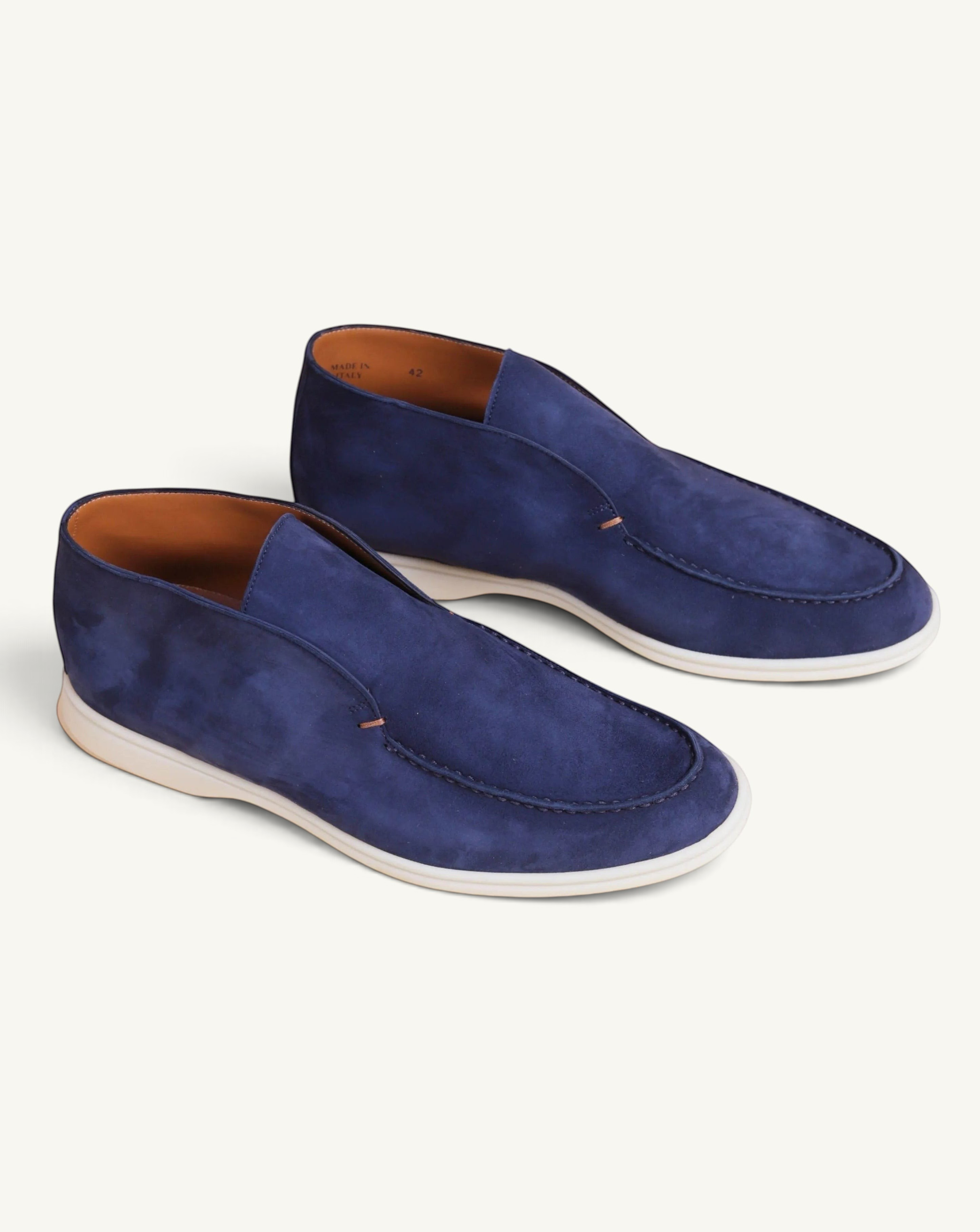 Prestige blue suede ankle boots with a white rubber sole and moccasin-style stitching