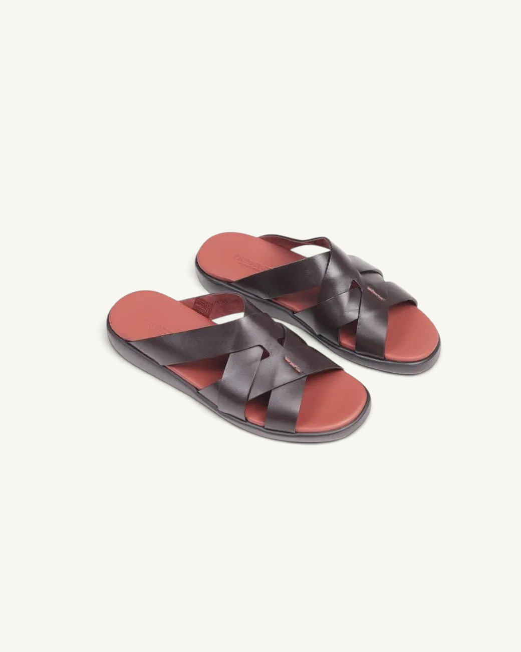 Prestige dark brown soft nappa calf leather sandals with a crisscross strap design and a contrasting red footbed.