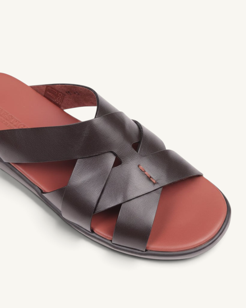 Prestige dark brown soft nappa calf leather slide sandal with a woven strap design and a contrasting red footbed.