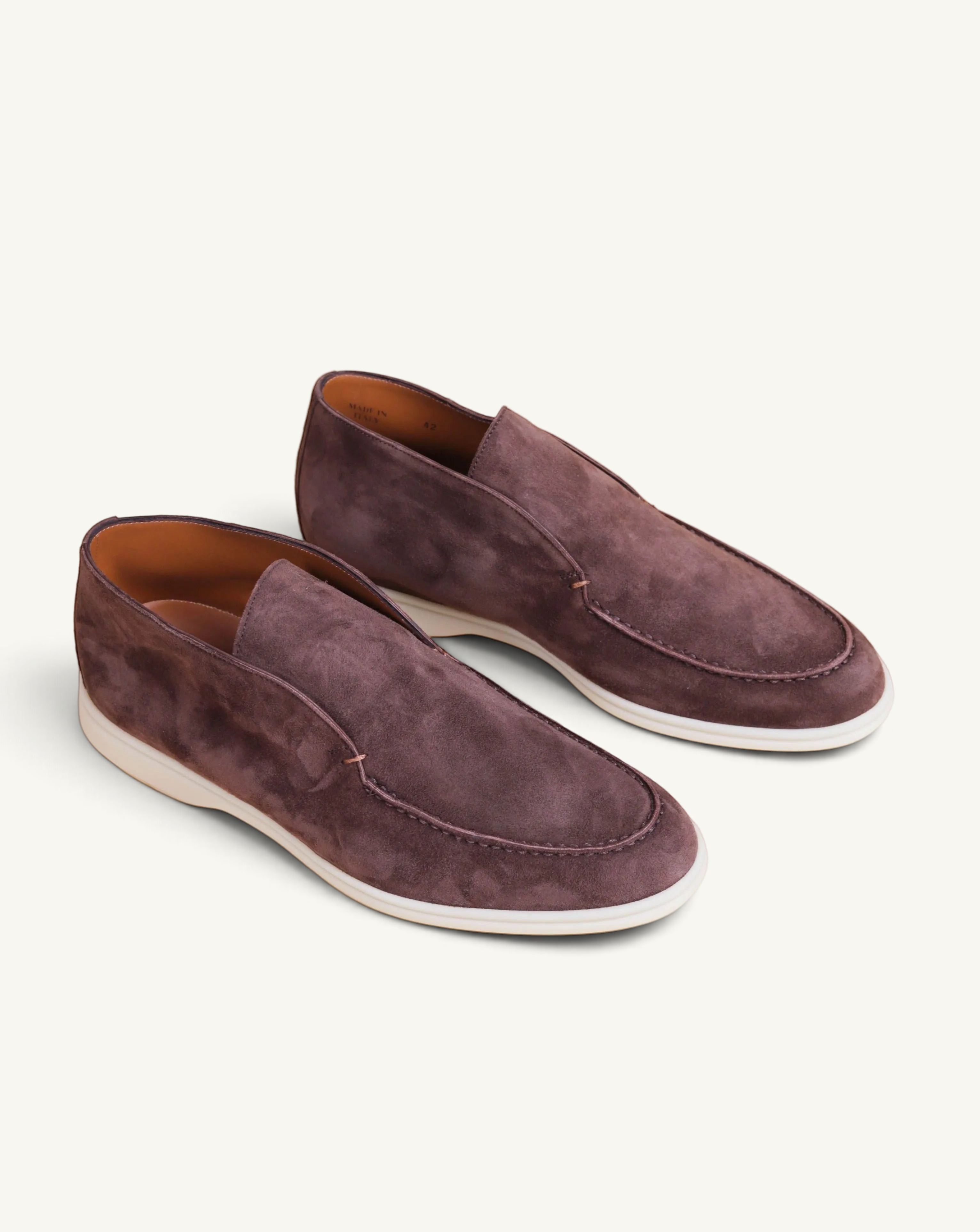 Prestige dark brown suede ankle boots with a slip-on design and a white rubber sole.