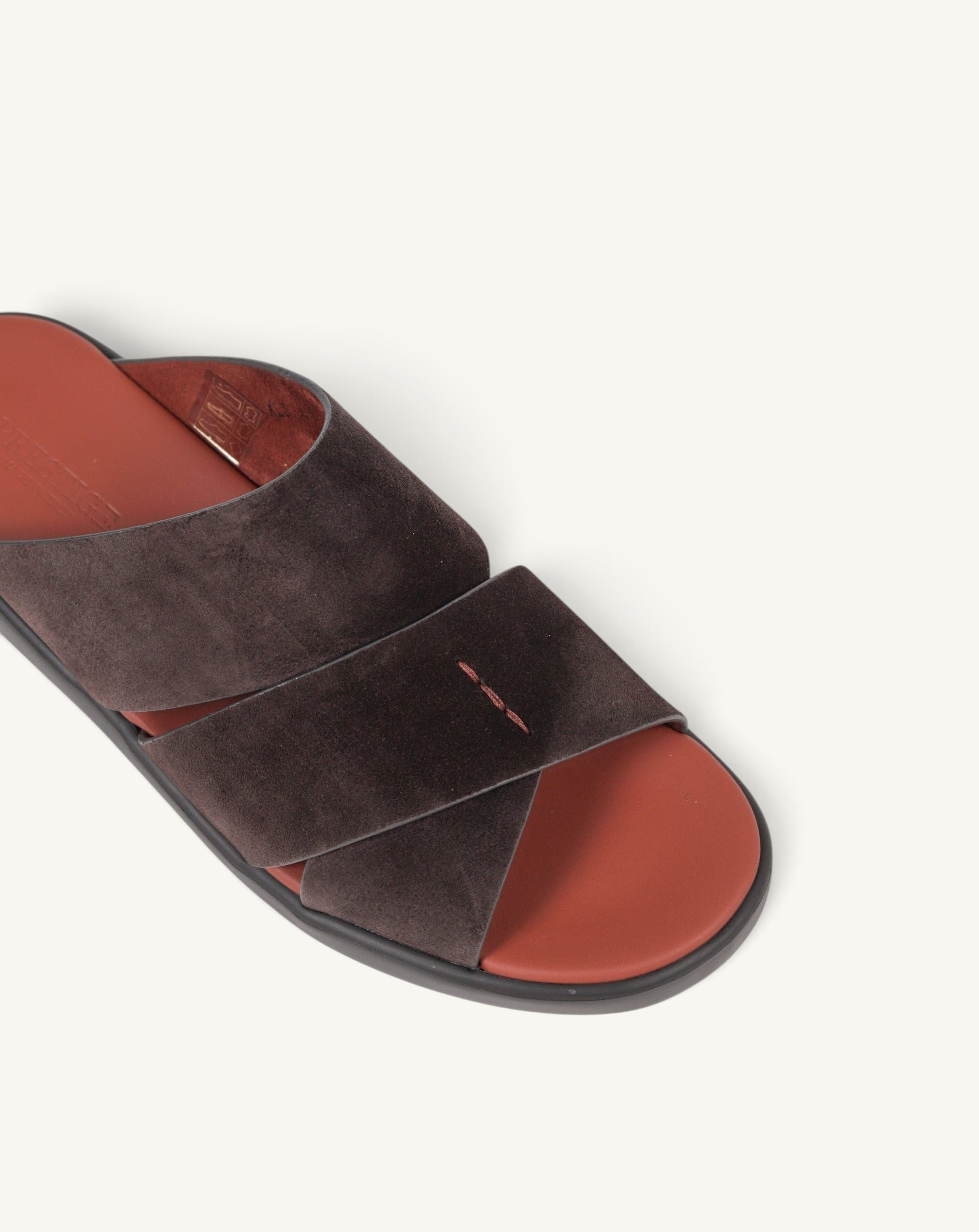 Prestige dark brown velour suede slide sandals with a crisscross strap design and a contrasting red footbed