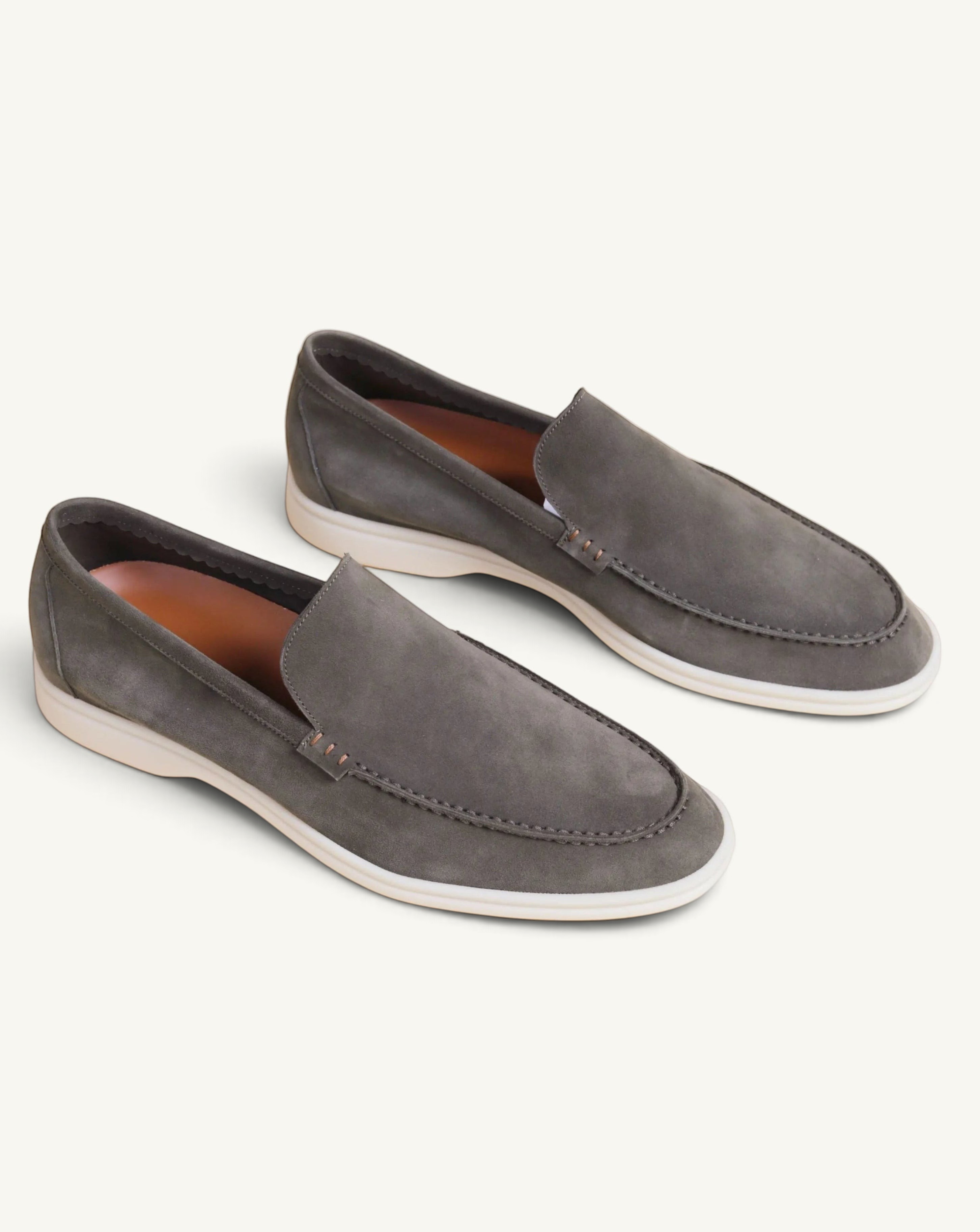 Prestige green suede loafers with a comfortable white rubber sole, featuring a classic slip-on design.