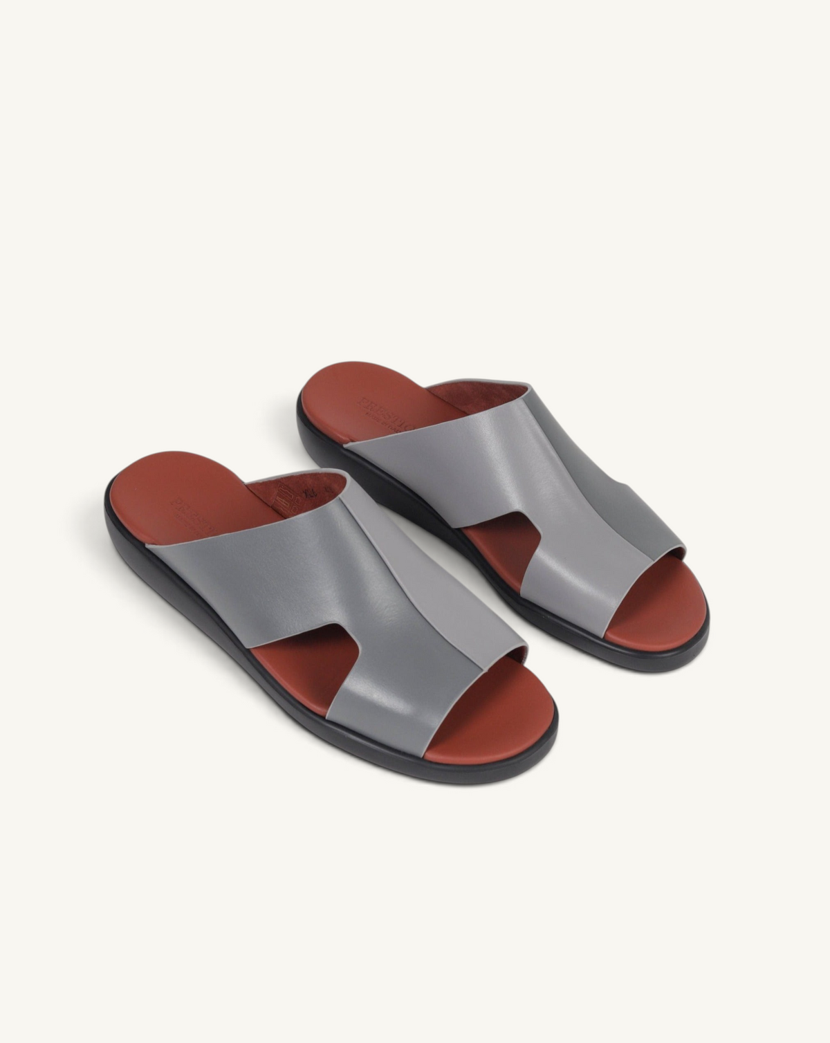 Prestige grey soft nappa calf leather slide sandals with a contrasting terracotta footbed and black sole.