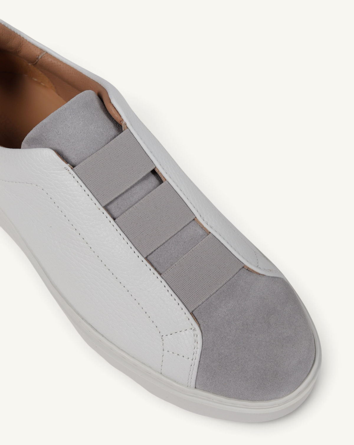 Prestige grey and white slip-on sneakers featuring a mix of grained leather and soft velour suede panels.