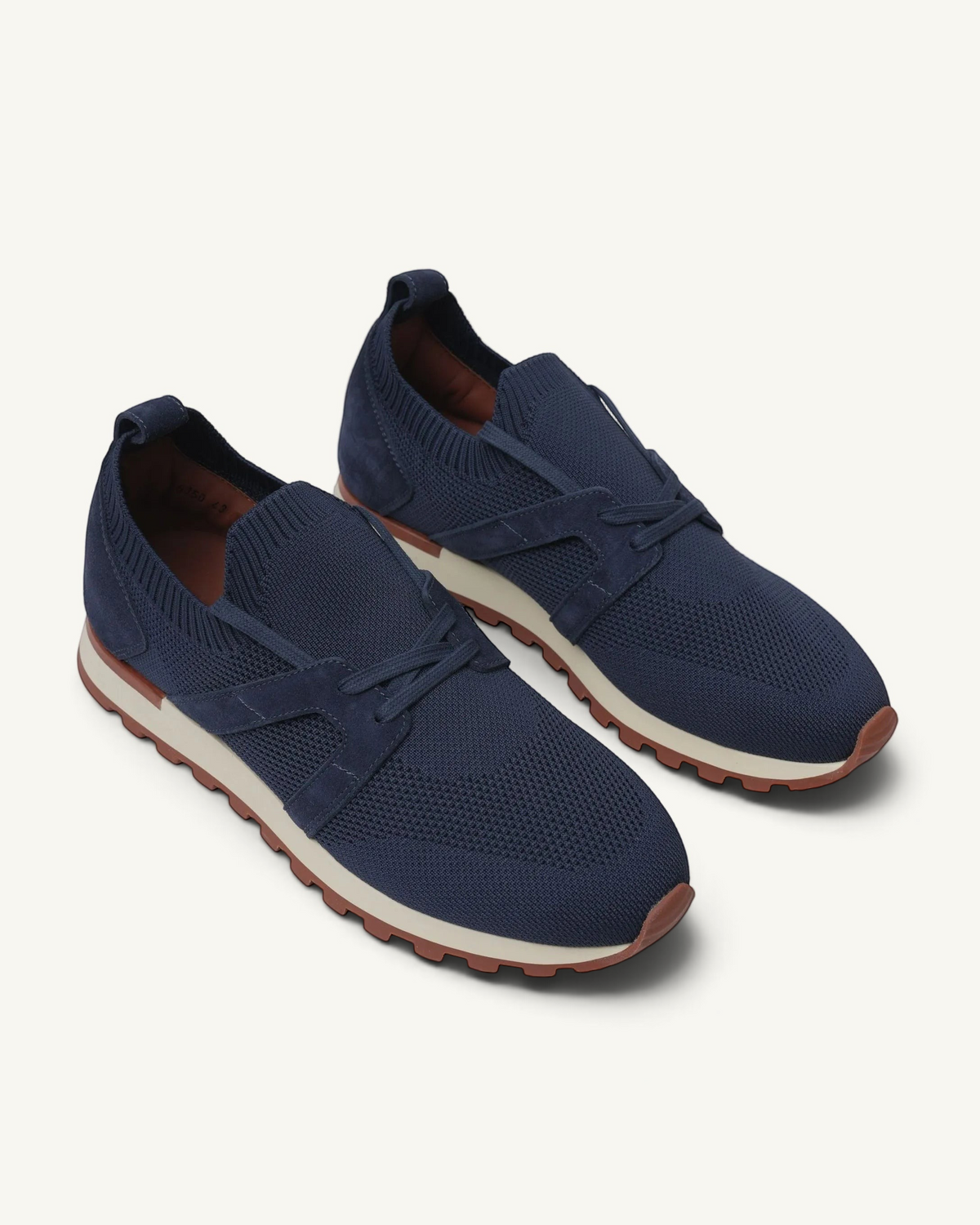 Prestige navy blue knit sneakers with suede accents and a comfortable white and brown rubber sole for casual walking.