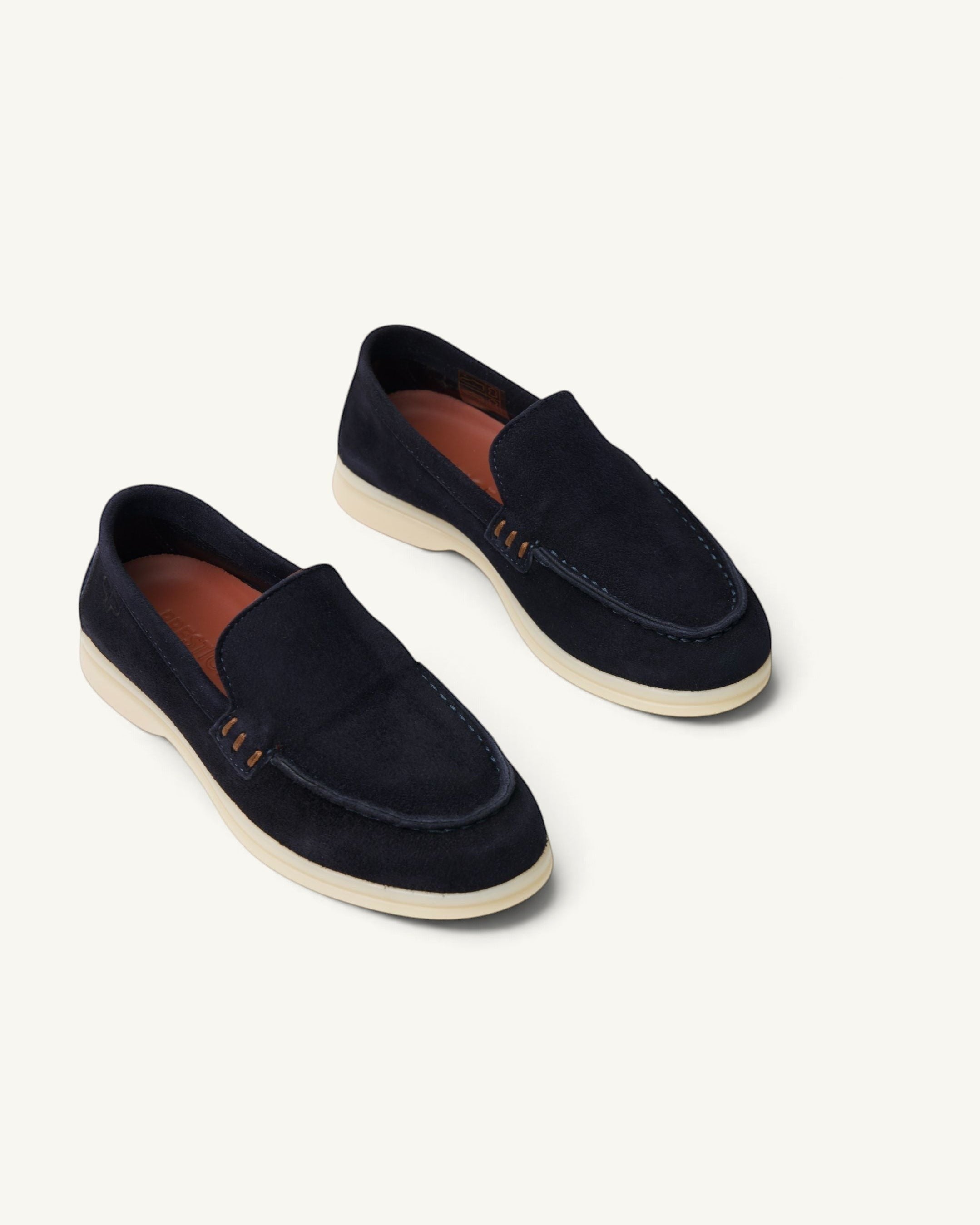 Prestige kids unisex navy blue suede loafers with a white rubber sole and stitched detailing