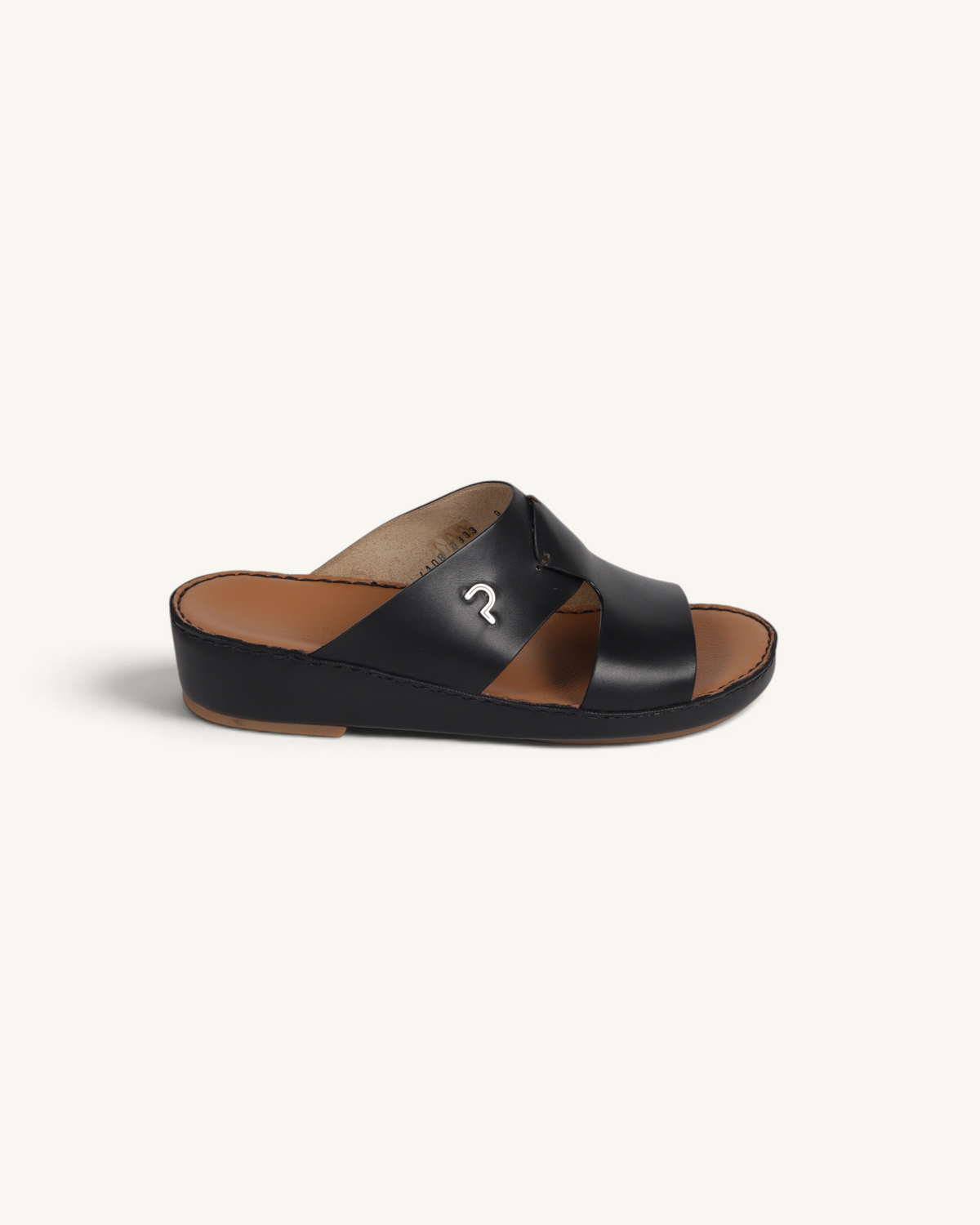 Prestige P3345 Phantom black leather slide sandal with a metallic logo detail and tan footbed.