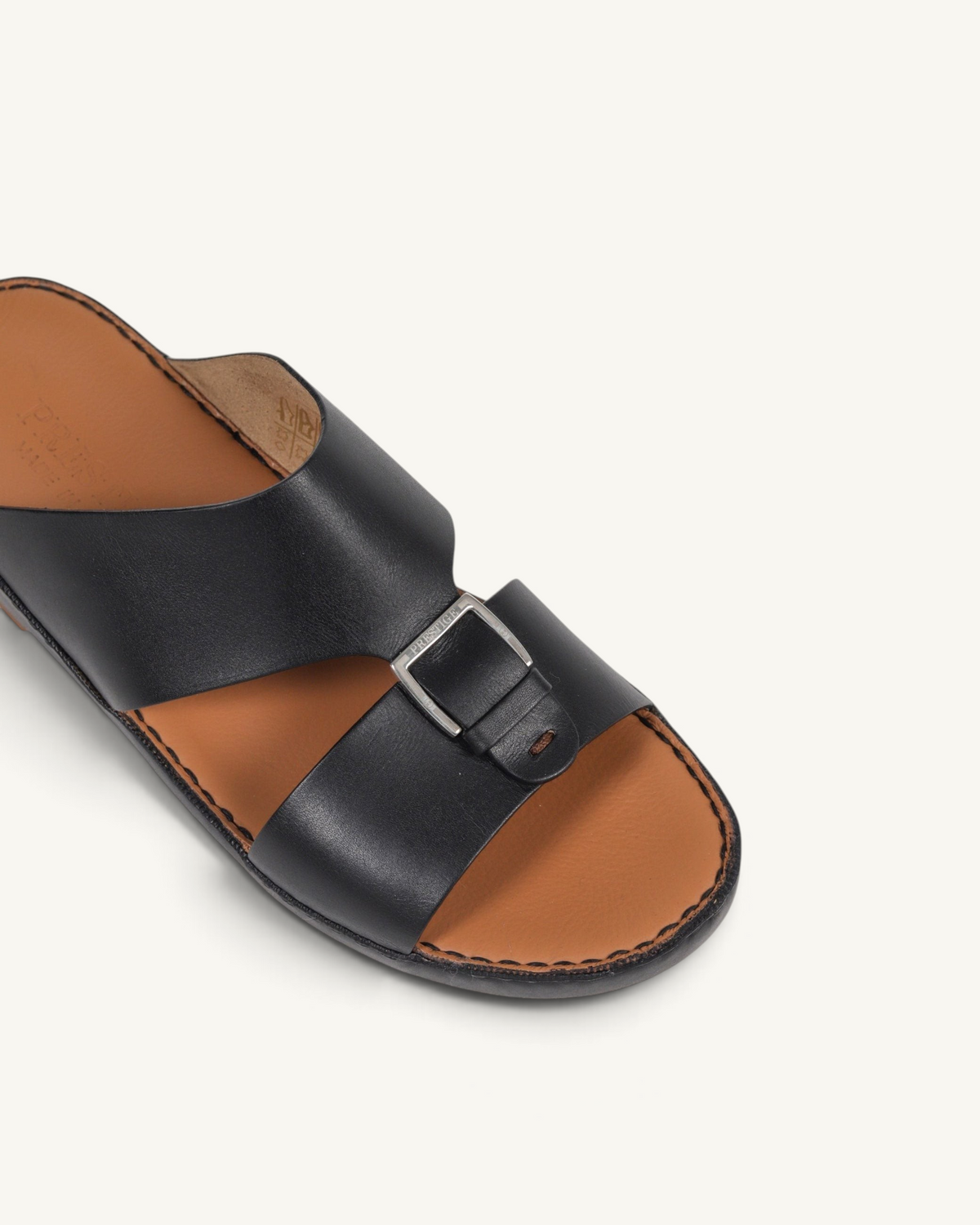 Prestige P3344 Phantom black leather slide sandals with a metallic buckle detail and tan leather footbed