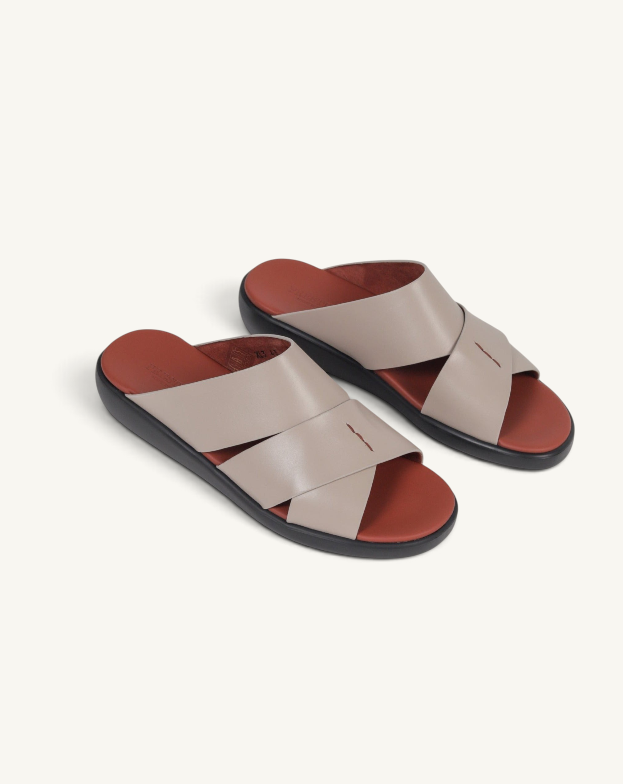 Prestige taupe soft nappa calf leather slide sandals with a crisscross strap design and a comfortable footbed.