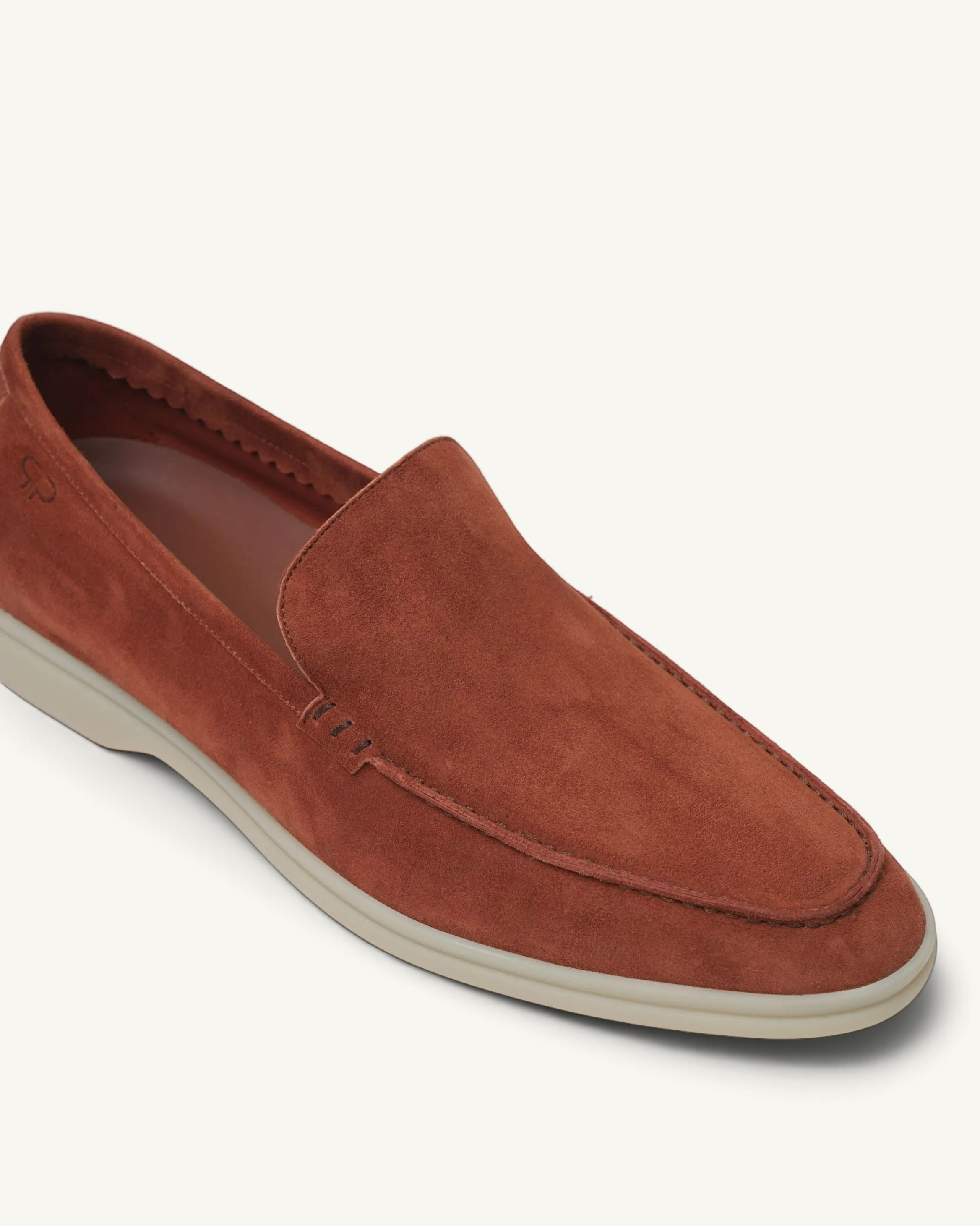 Prestige whisky brown suede loafer with a comfortable white rubber sole and stitched moccasin toe detail.