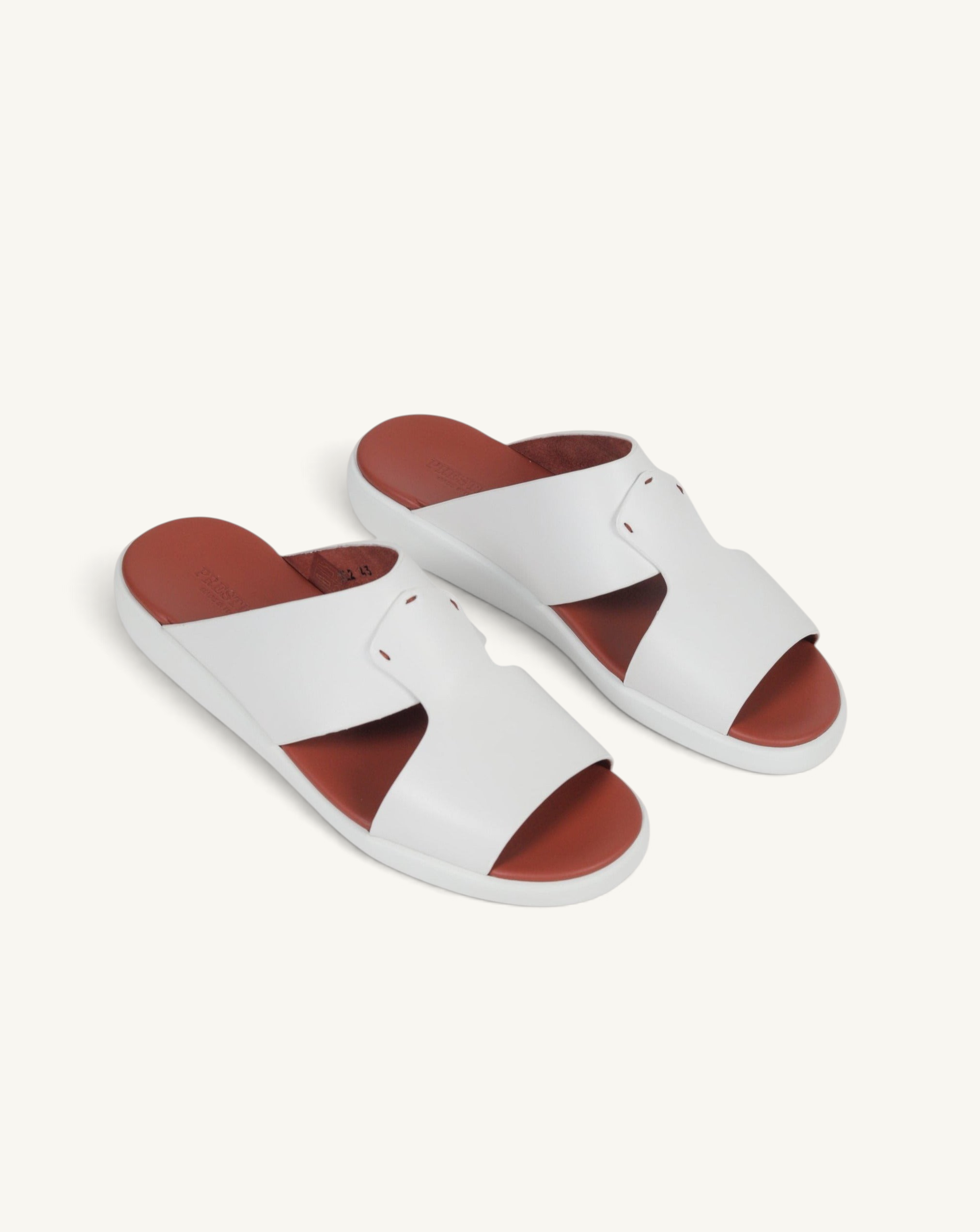 Prestige white soft nappa calf leather slide sandals with a contrasting tan footbed and comfortable flat sole.