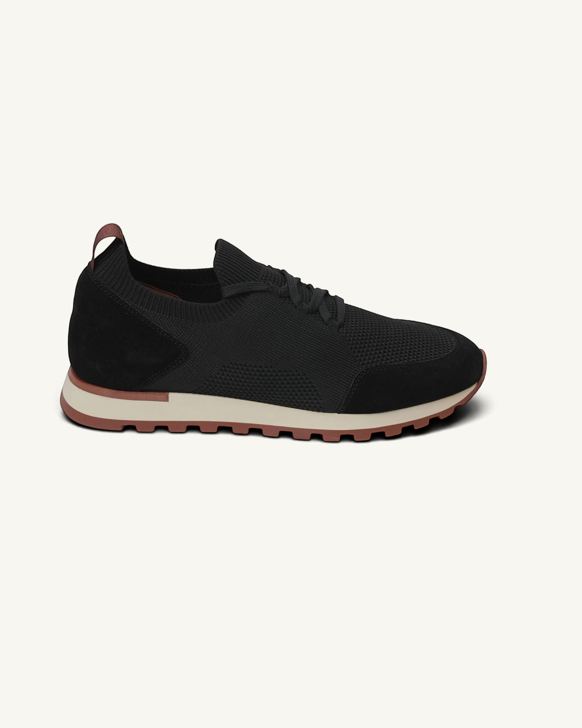 Prestige Flexy Lux Walk black sneakers with a knit upper, suede overlays, and a contrasting beige and rust sole.