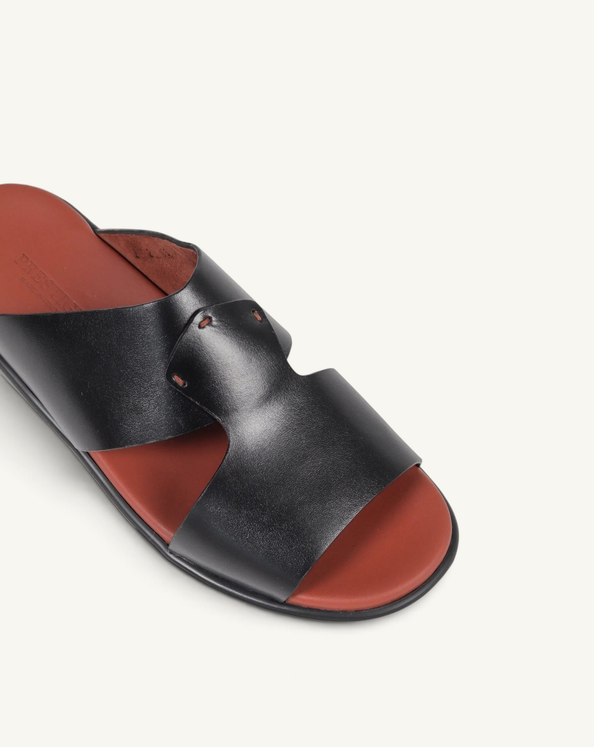 Prestige black soft nappa calf leather slide sandals with a contrasting rust-coloured footbed.