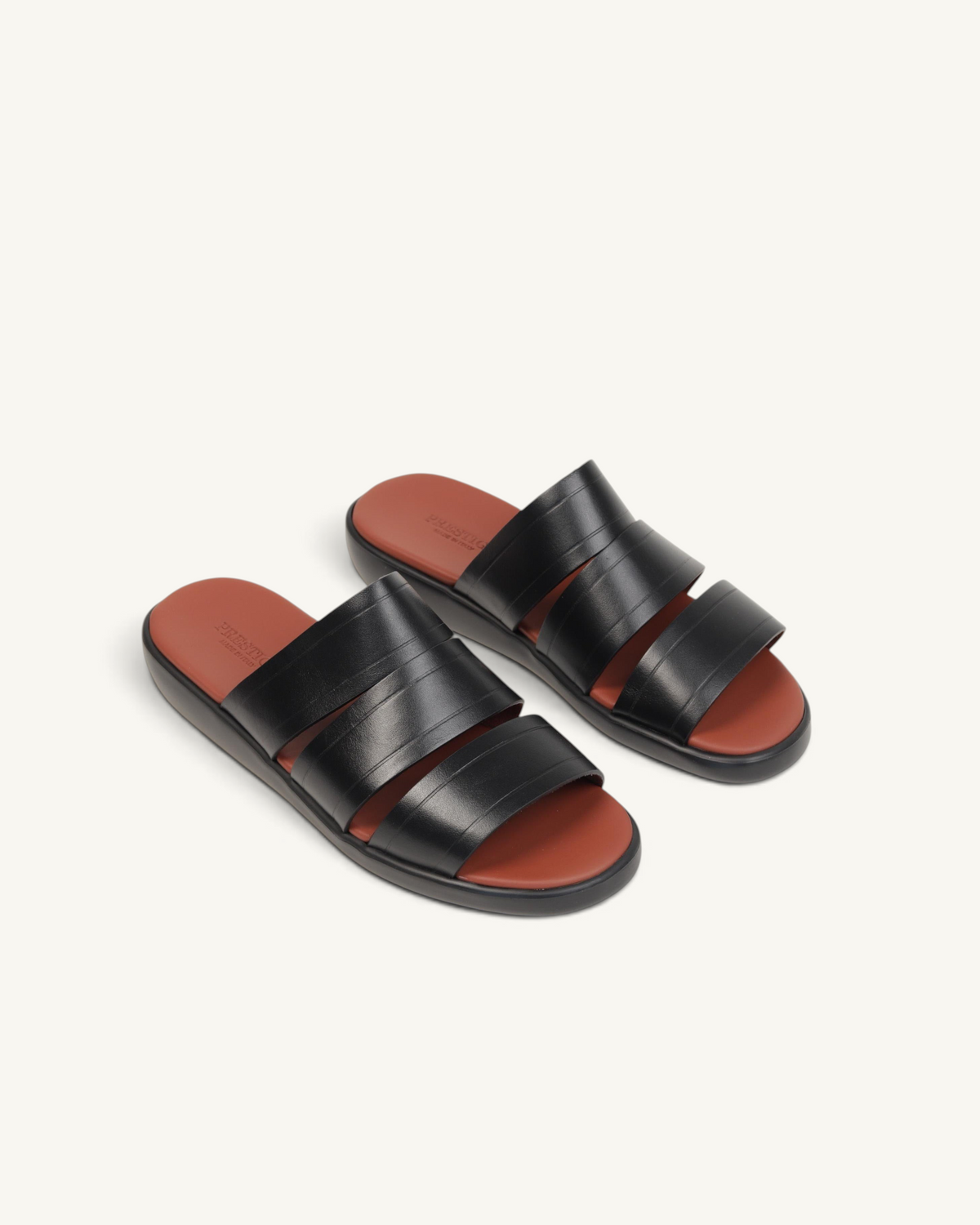Prestige black soft nappa calf leather slide sandals with three wide straps and a contrasting brown footbed.