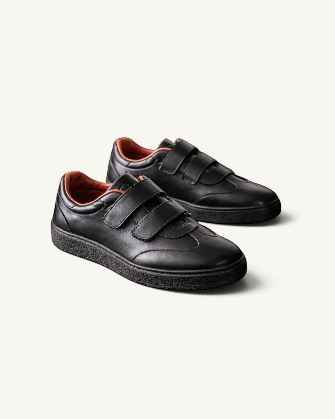 Prestige Kid’s Tennis Walk unisex sneakers in black nappa calf leather with double velcro straps and tan lining.