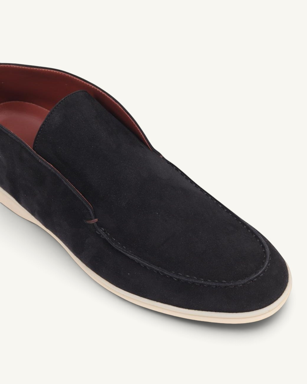 Prestige black suede slip-on ankle boot with a contrasting white sole and smooth leather interior lining.