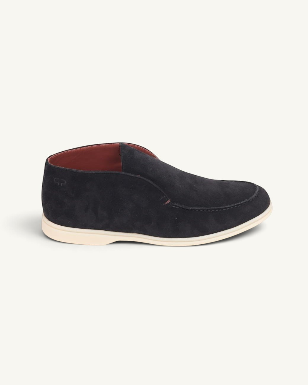 Prestige black suede ankle boot with a low profile, moccasin-style stitching, and a contrasting cream rubber sole.