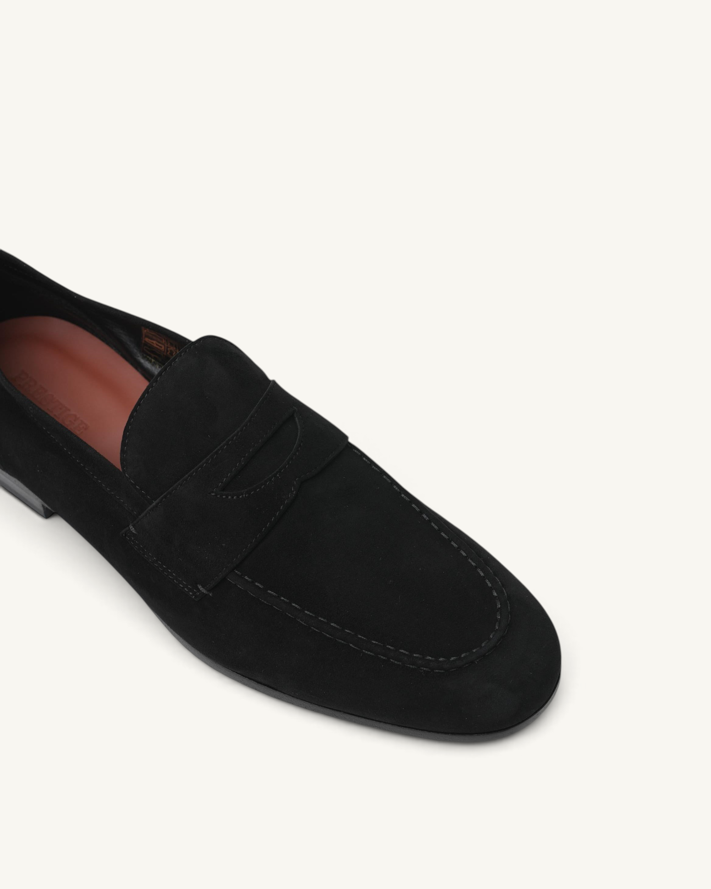 Prestige men's black suede loafer with classic penny strap detail, shown from a top-down angle.