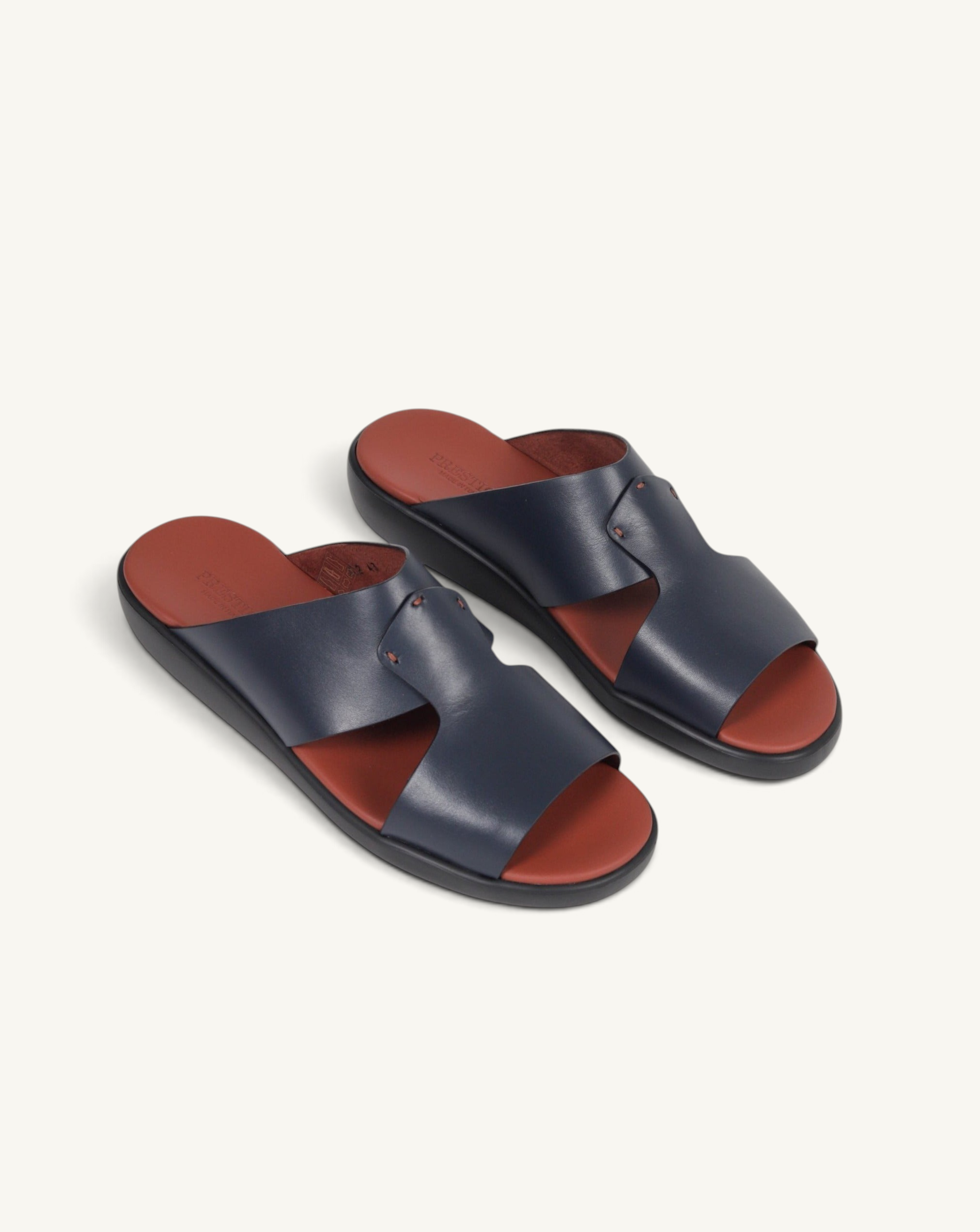 Prestige blue soft nappa calf leather slide sandals with a contrasting rust-coloured footbed and black sole.