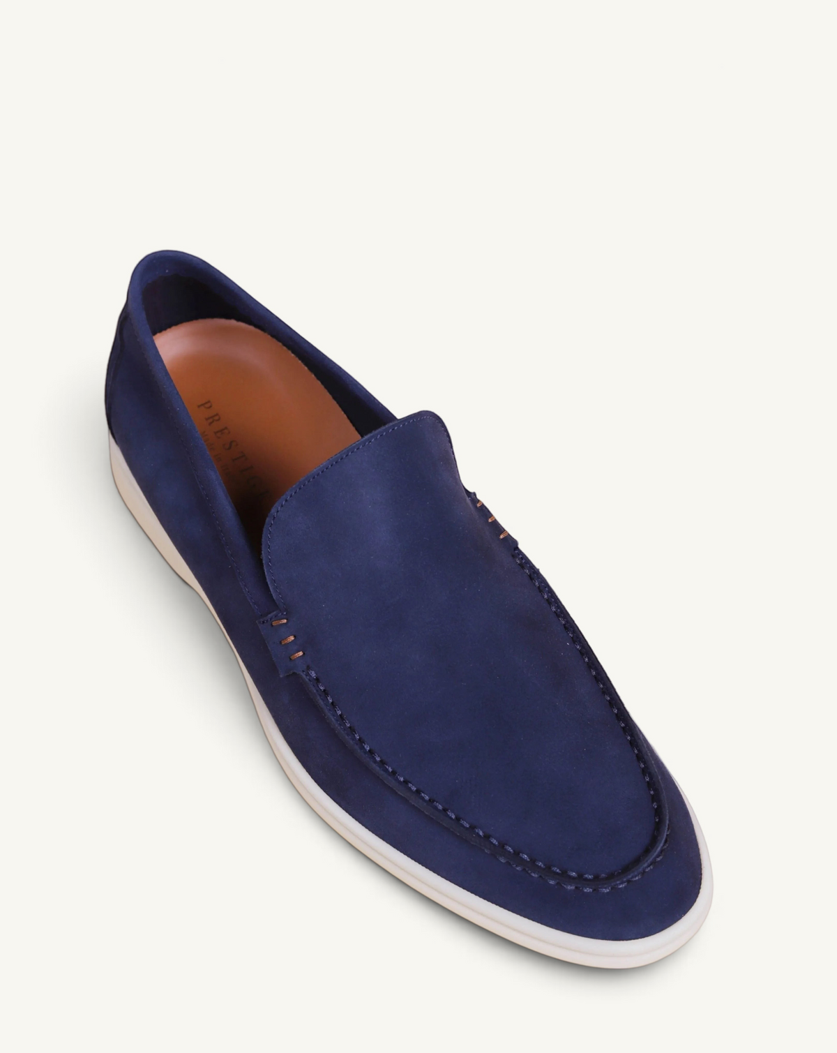 Prestige blue suede loafer with white rubber sole and moccasin-style stitching detail