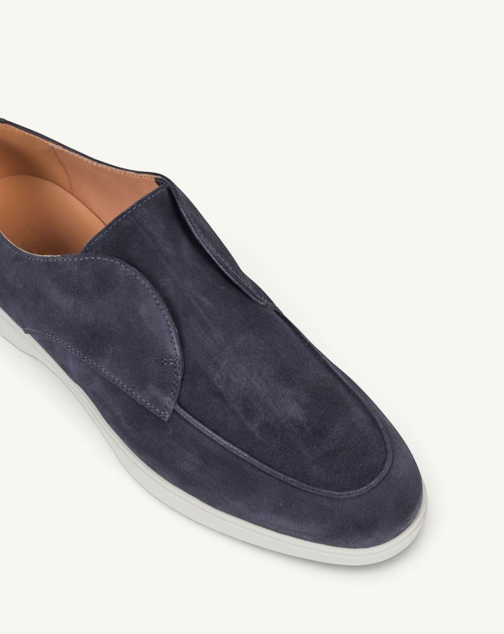 Prestige blue suede loafers with a sleek slip-on design and a contrasting white rubber sole.