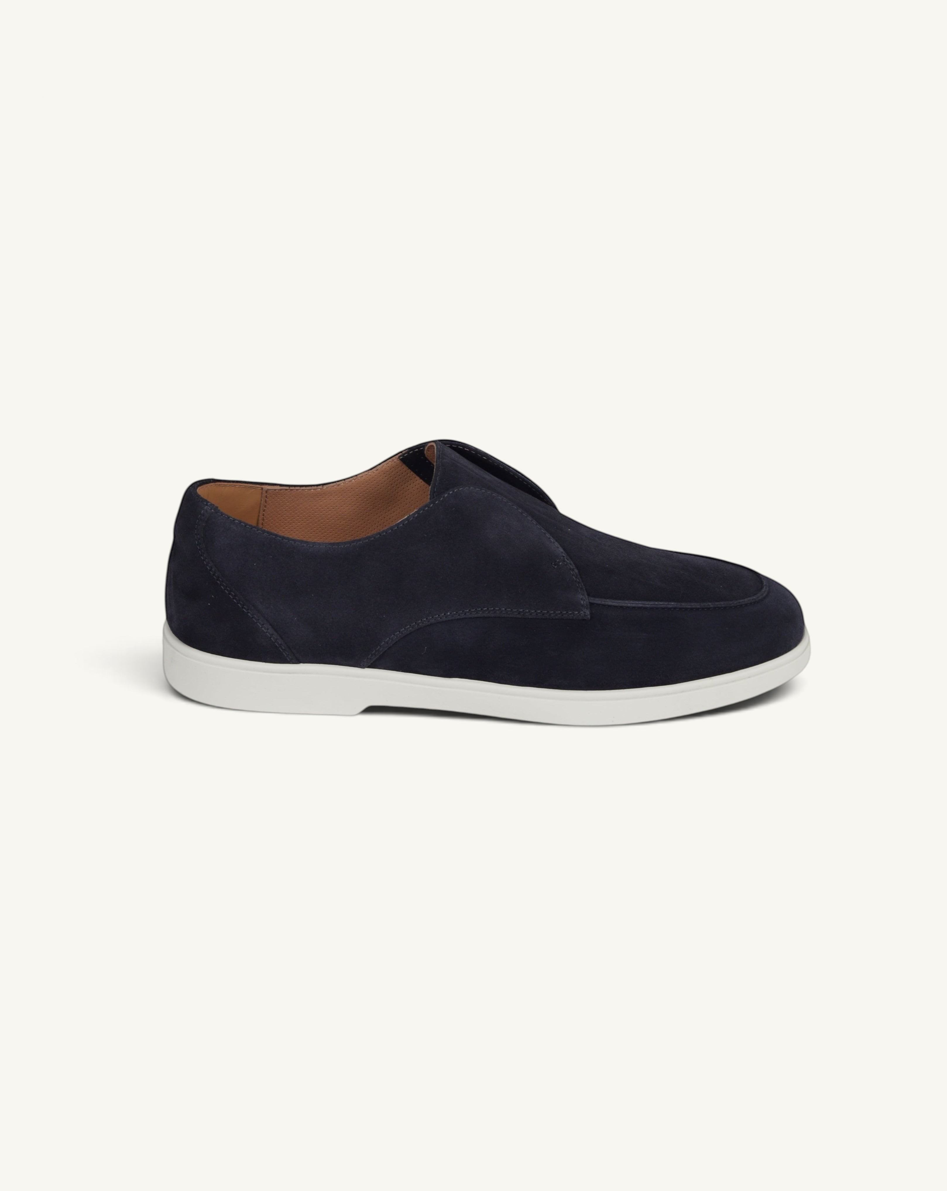 Prestige blue suede loafers with a sleek slip-on design and a contrasting white rubber sole.