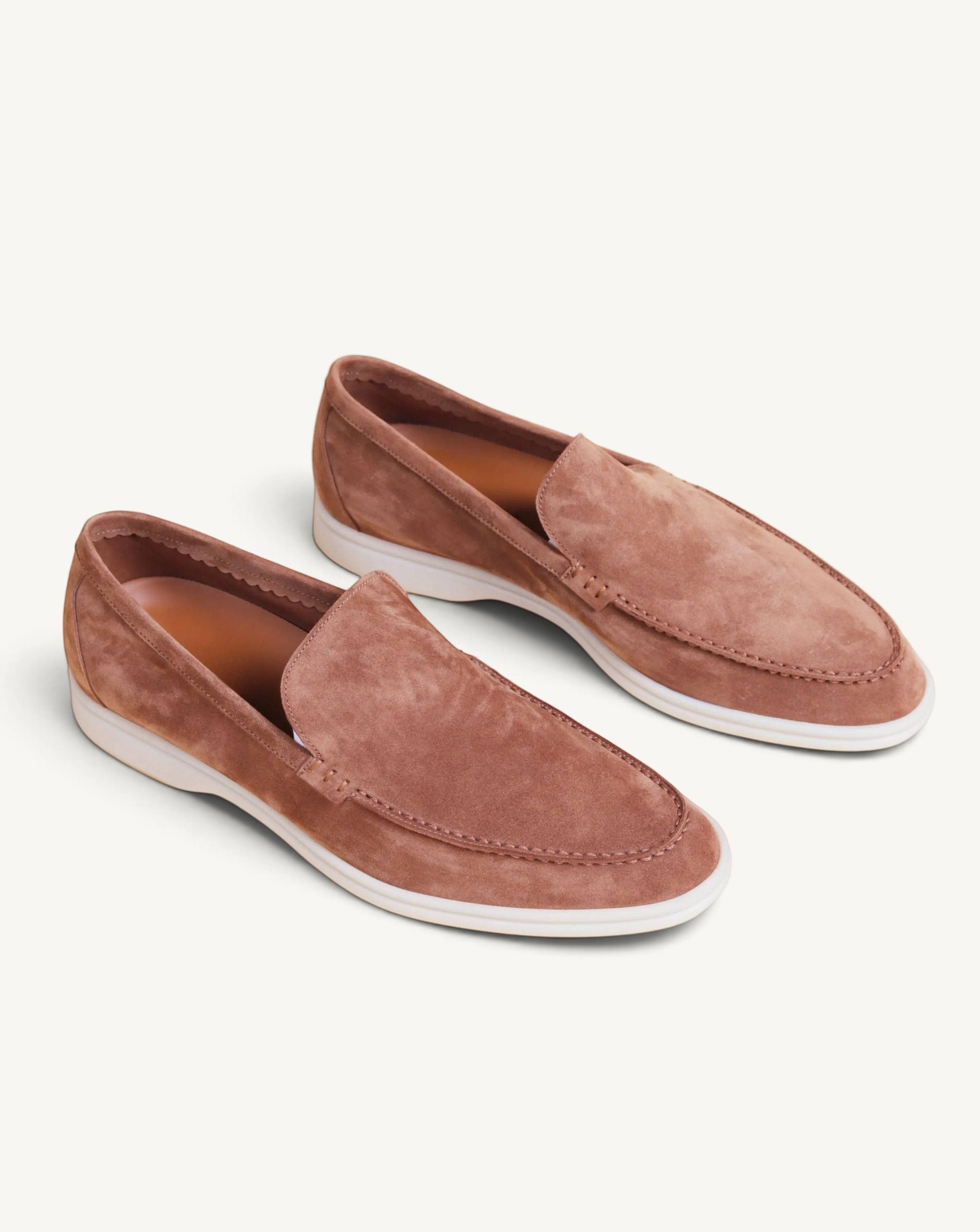 Prestige brown suede loafer shoes with a white rubber sole and moccasin-style stitching