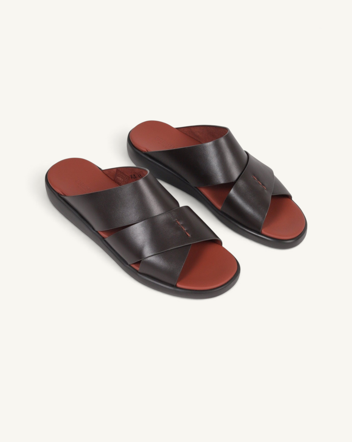 Prestige dark brown soft nappa calf leather slide sandals with a comfortable rust-colored footbed and cross straps.