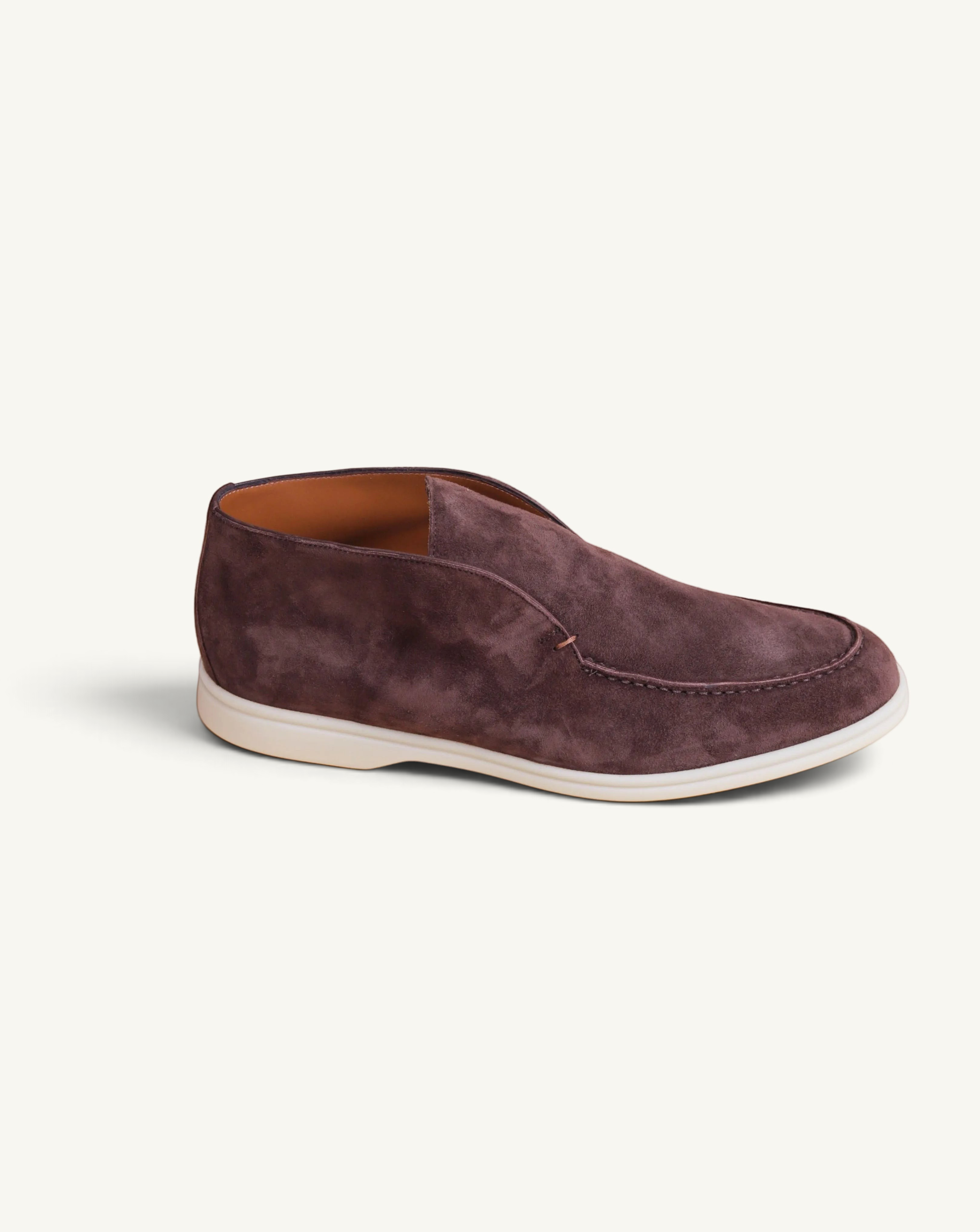 Prestige dark brown suede ankle boot with a clean slip-on design and a contrasting white rubber sole.