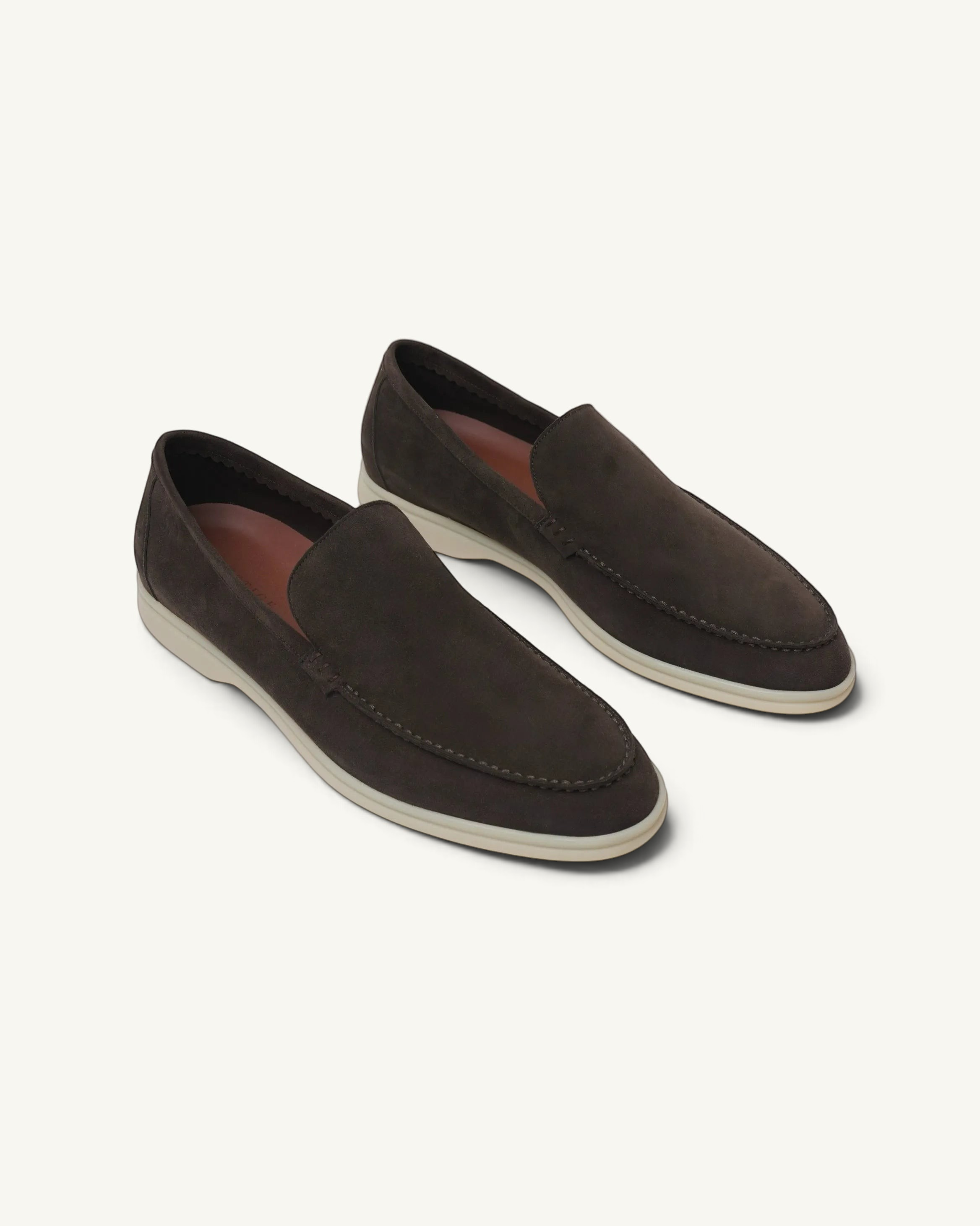 Prestige dark brown suede loafers with a white rubber sole, featuring a classic slip-on design.