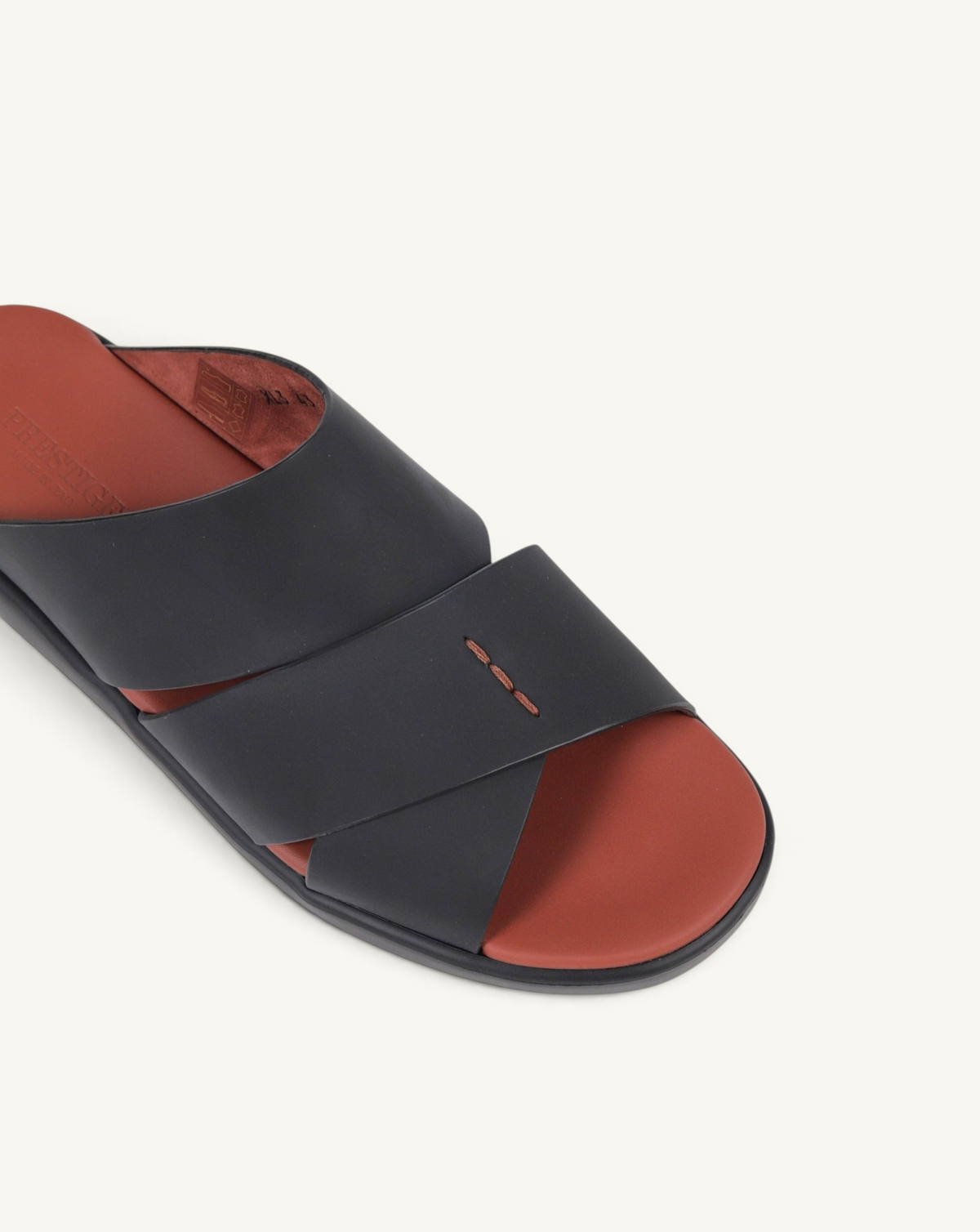 Prestige PG-XL3 Gommato black leather slide sandals with a contrasting rust-colored footbed and cross-strap design.