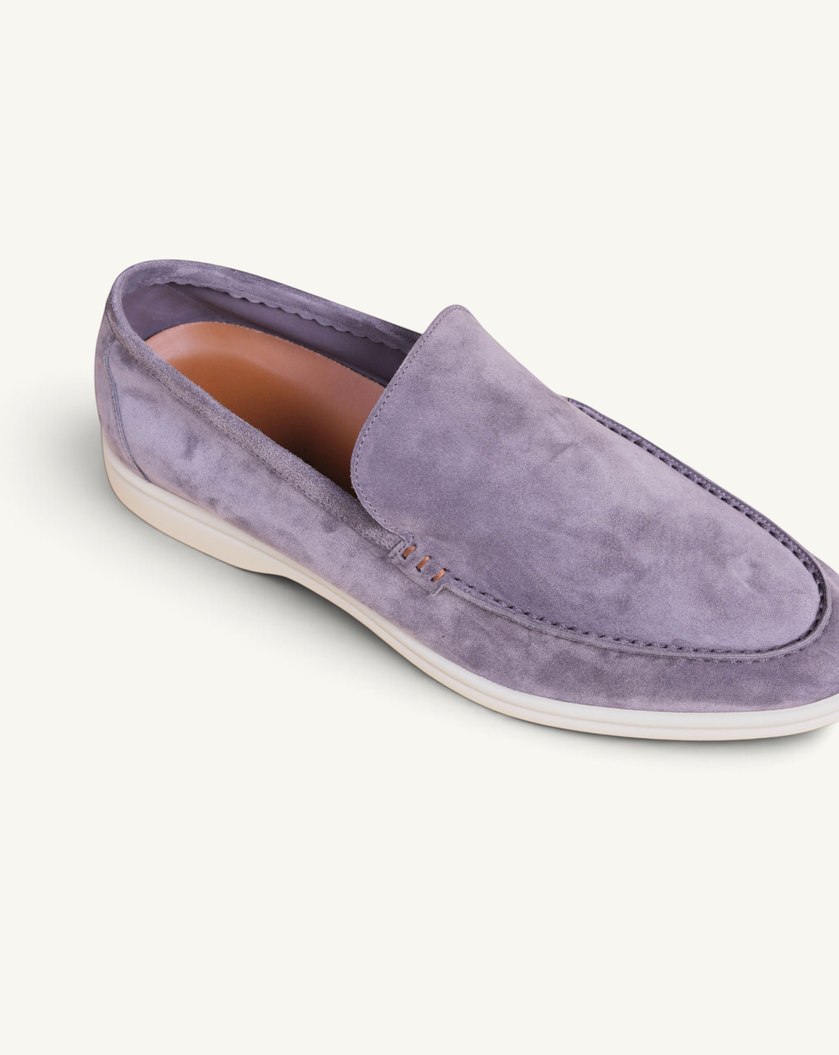 Prestige grey suede loafer with a white rubber sole, featuring detailed stitching and a comfortable tan leather lining.