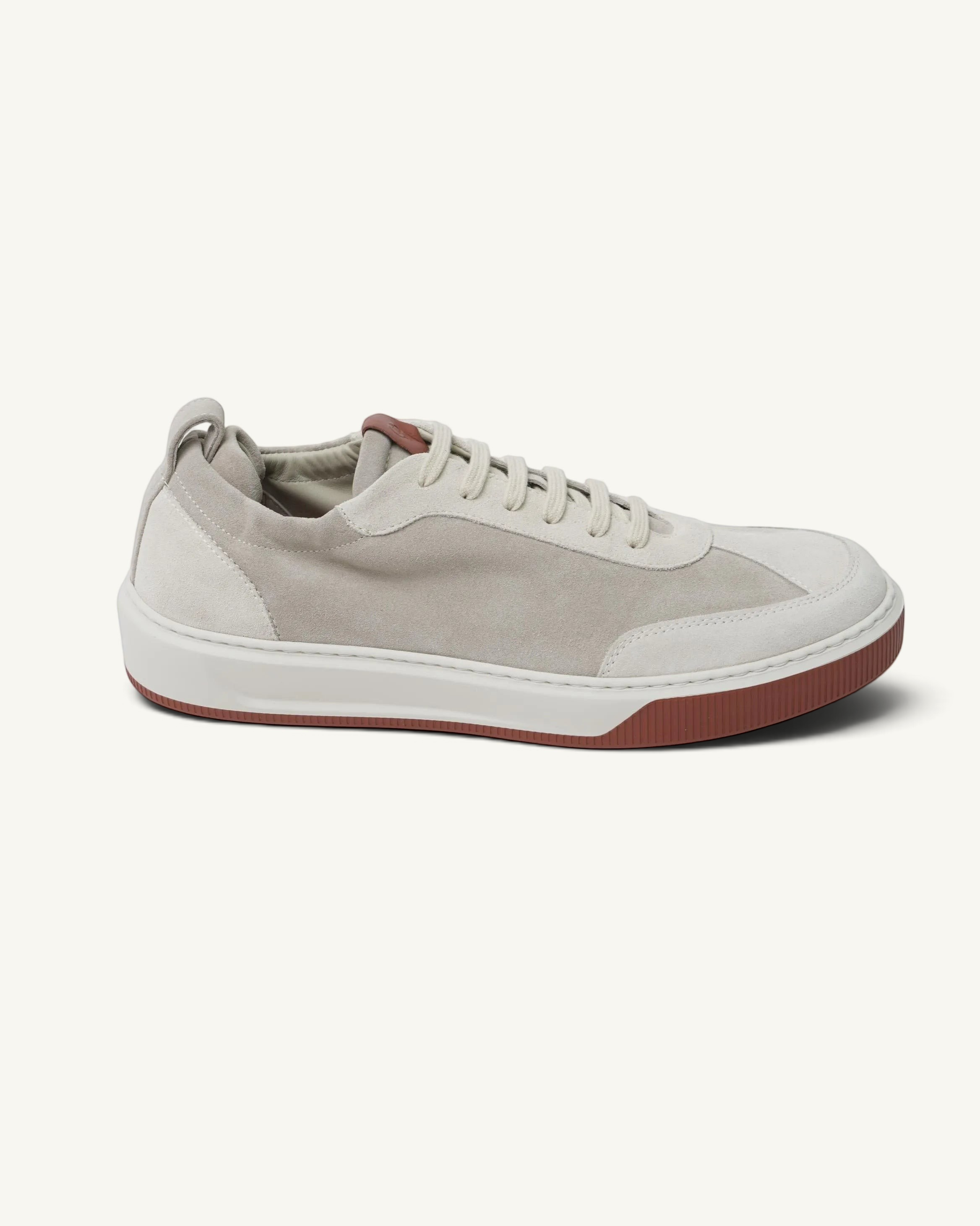 Prestige Legacy Walk Reverse beige suede sneakers with a contrasting dark red rubber sole and lace-up closure.