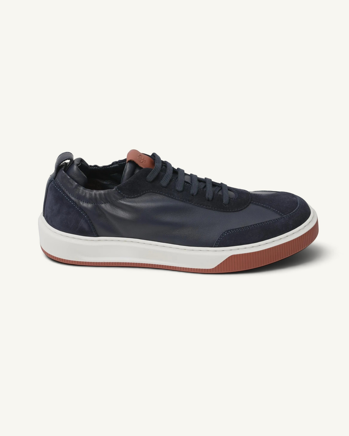 Prestige Legacy Walk Reverse men's sneaker in navy blue leather and suede with a contrasting terracotta rubber sole.