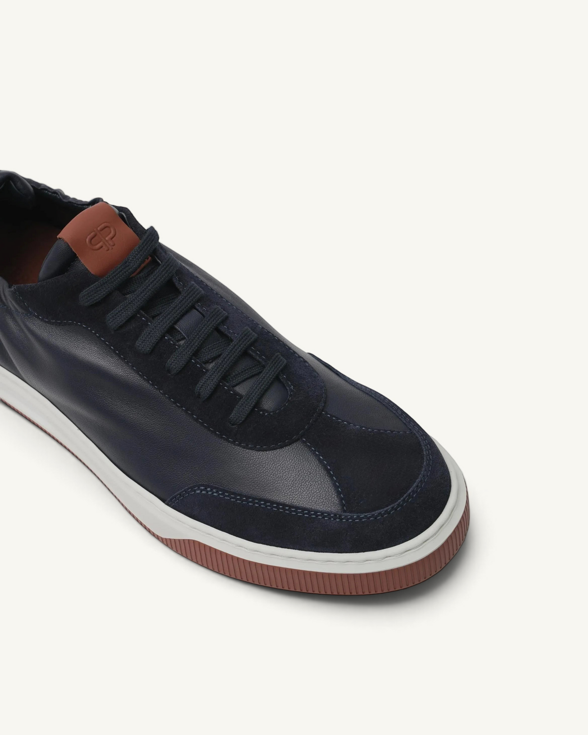 Prestige Legacy Walk Reverse men's sneaker in navy blue leather and suede with a brown tongue patch and white sole.