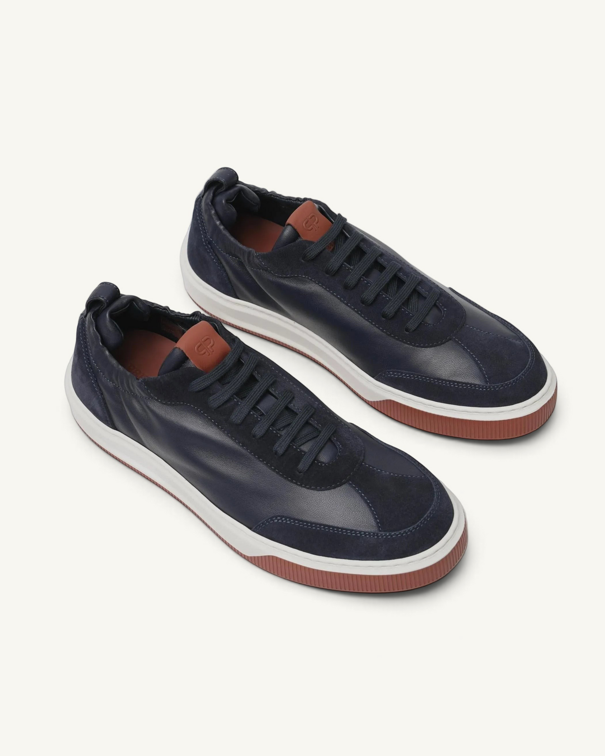 Prestige Legacy Walk Reverse men's sneakers in navy blue leather and suede with a contrasting brick-red rubber sole.