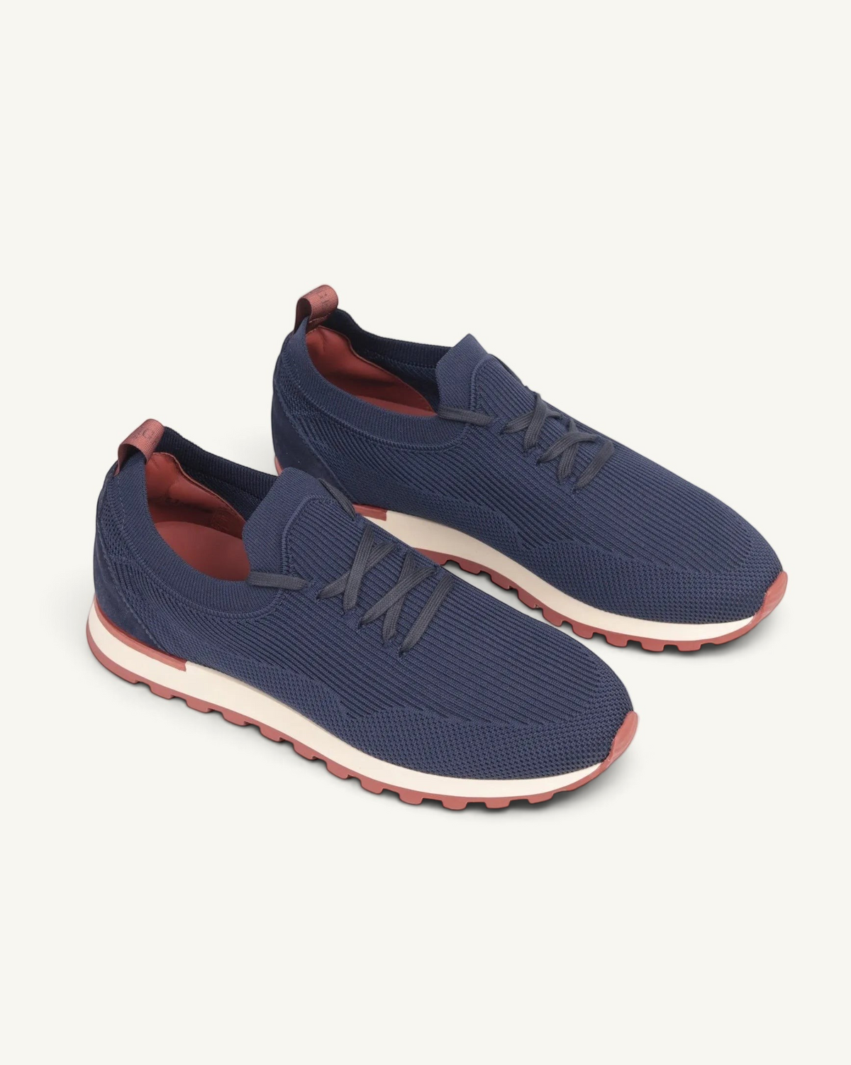 Prestige Flexy Lux navy blue knit running sneakers with a white and rust-colored lugged sole.