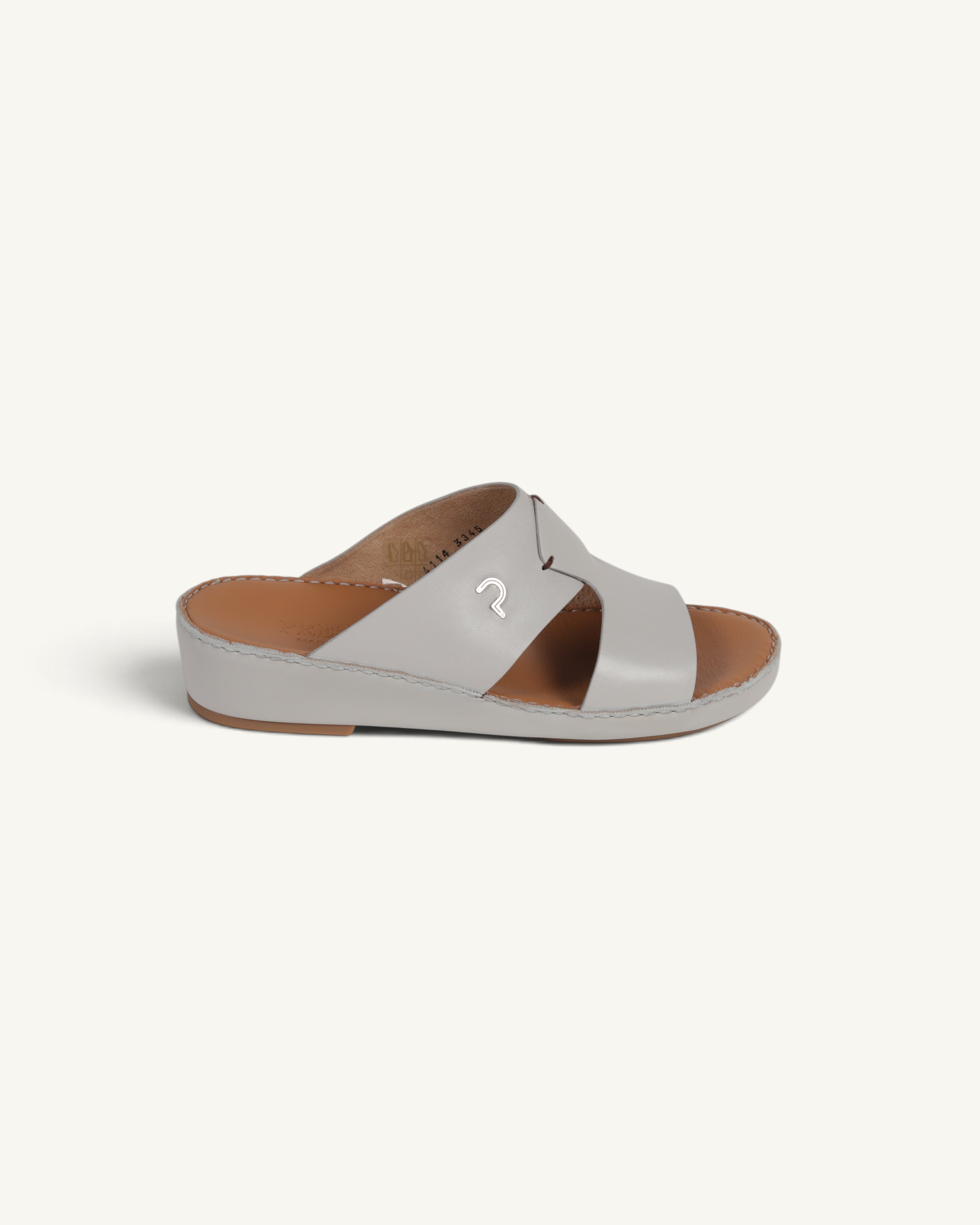 Prestige P3345 Phantom NC Perla slide sandals in light grey leather with a metallic logo detail and tan footbed