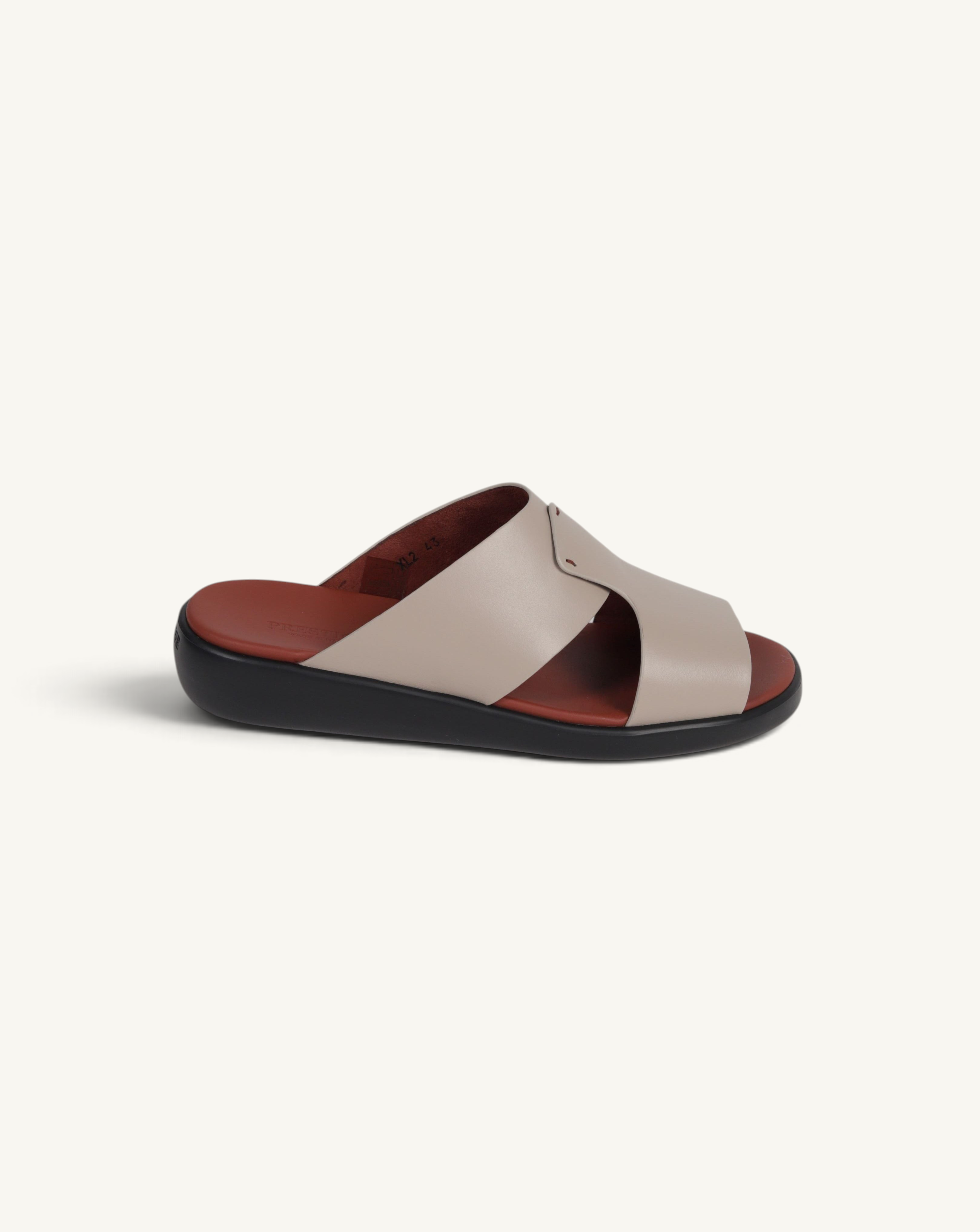 Prestige taupe soft nappa calf leather slide sandal with a comfortable dark brown footbed and black sole