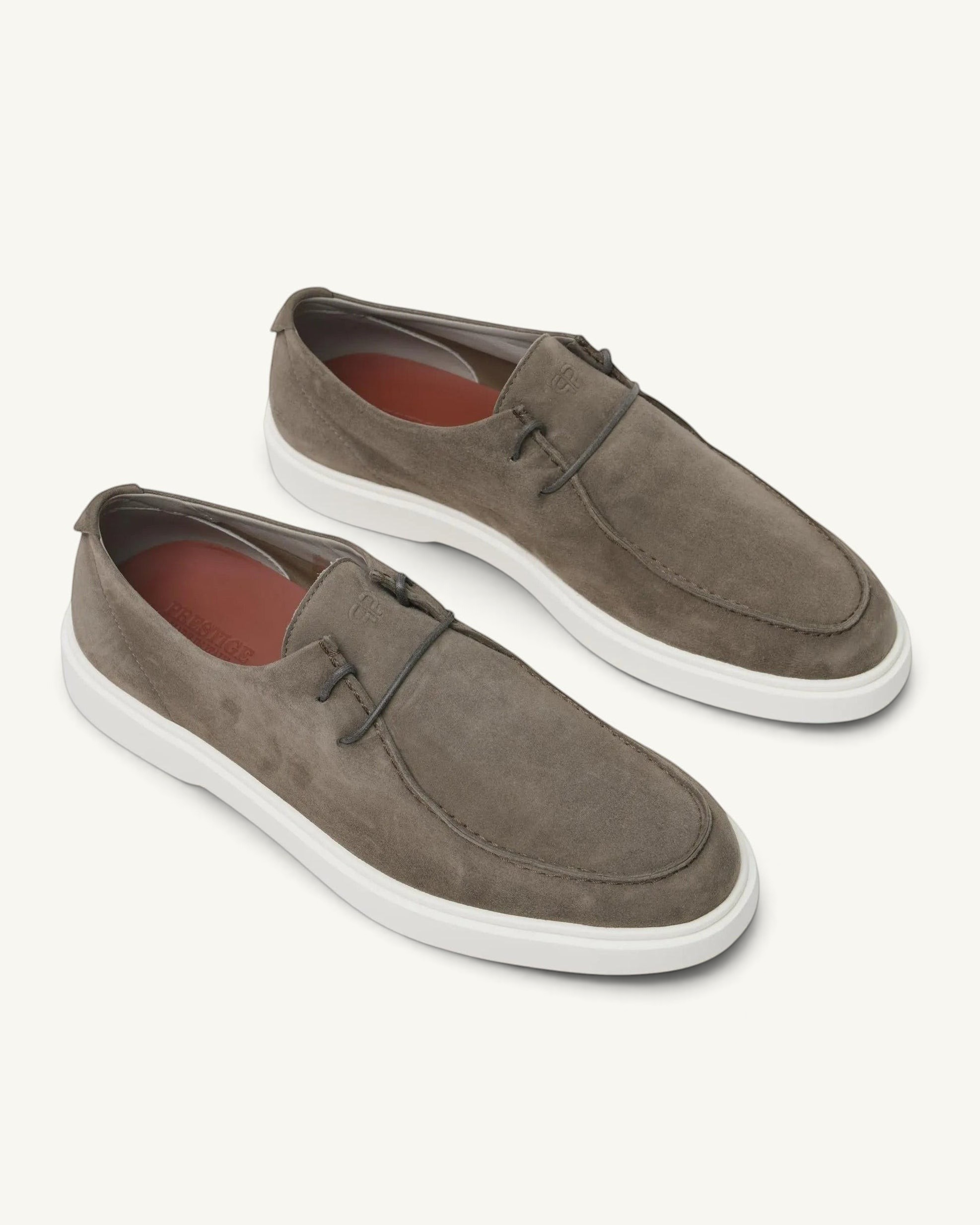 Prestige Playtime Reverse men's loafers in taupe suede with a white rubber sole and minimalist lace-up detail.