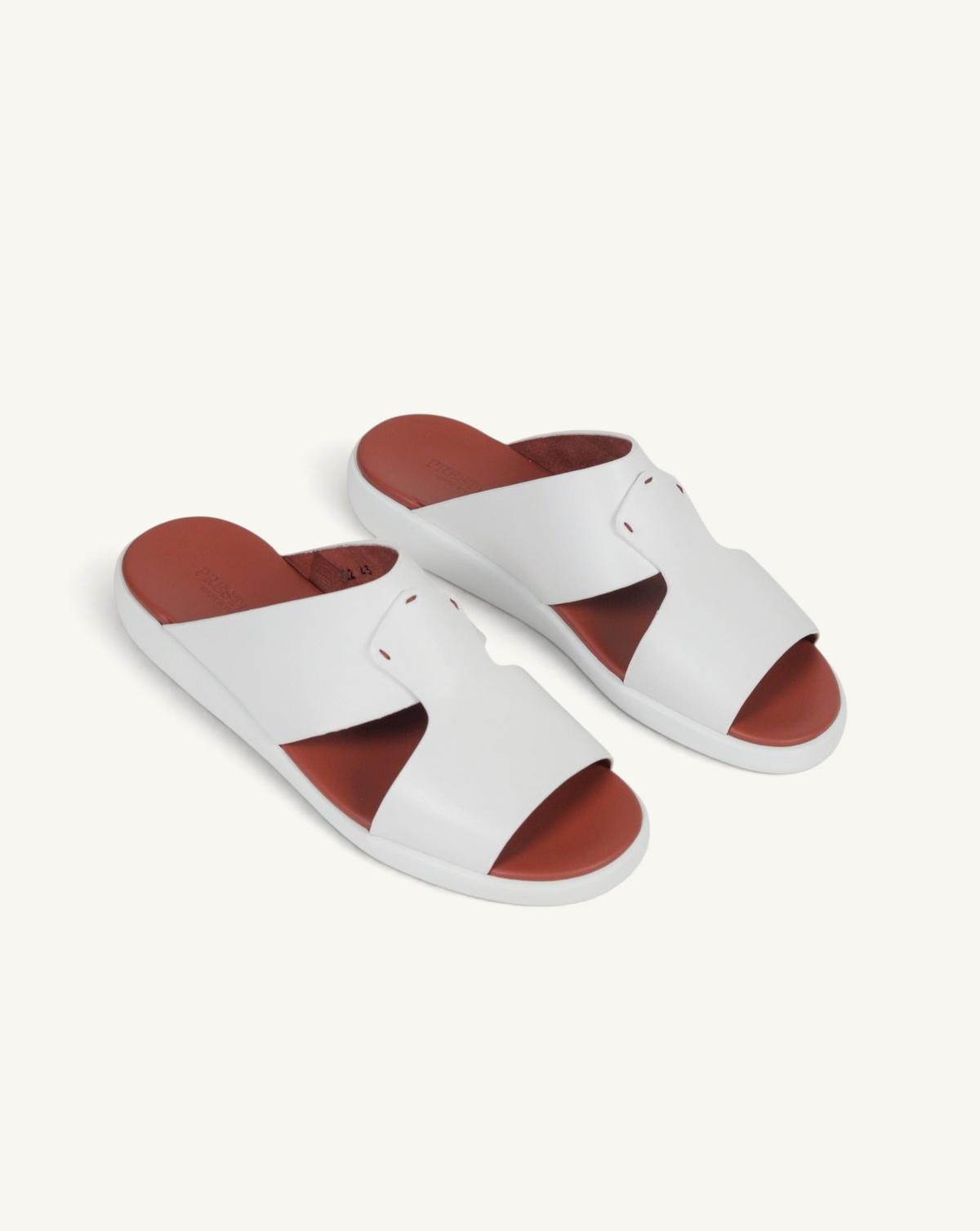 Prestige white soft nappa calf leather slide sandals with a contrasting tan footbed and comfortable flat sole.
